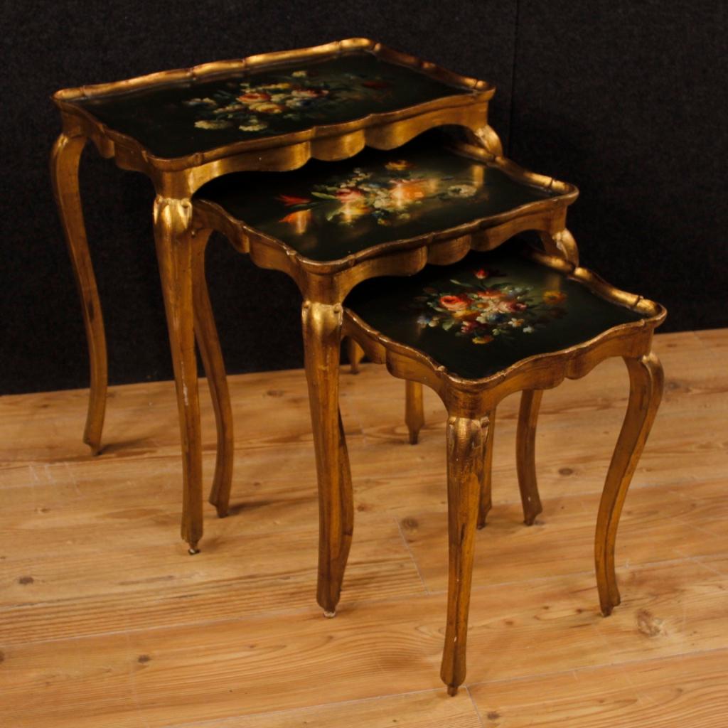 Triptych of Italian coffee tables from 20th century. Furniture in carved, gilded and hand painted wood with floral decorations of great pleasure. Coffee tables ideal to be placed in a living room but that can be easily placed in different parts of