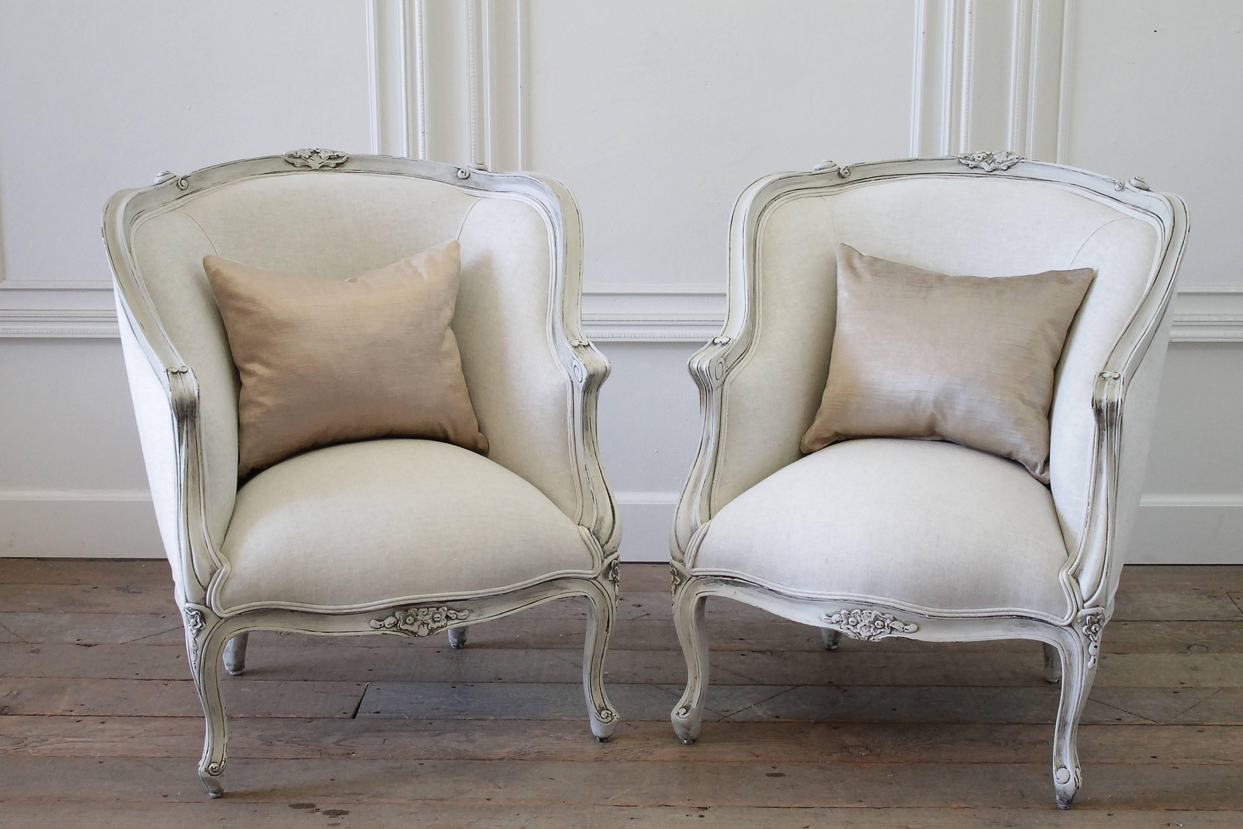 20th century painted and upholstered pair of linen Bergere chairs

These frames have been refinished in a soft pale oyster white, with a subtle grey undertone. The frames have a subtle distressed finished and hand glazed patina. Upholstery is done