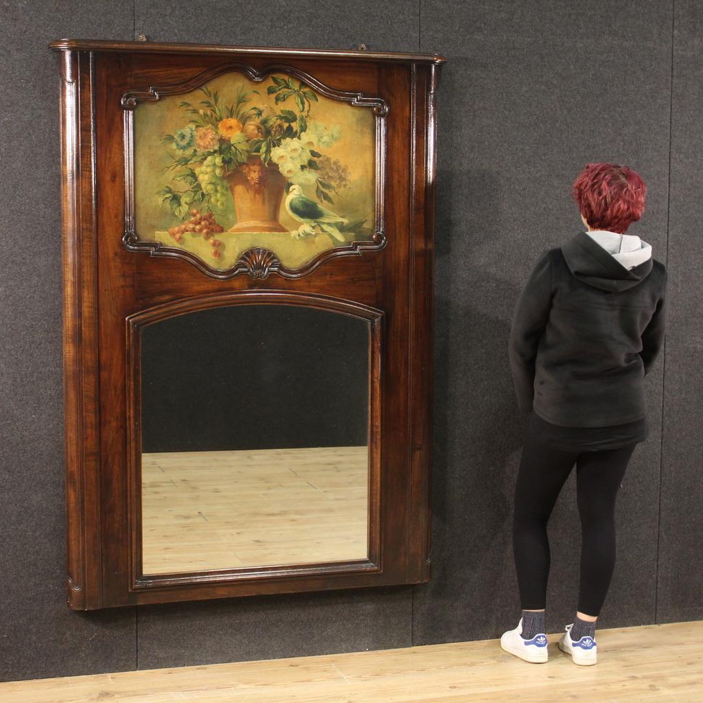 Great Italian mantelpiece mirror from the mid-20th century. Furniture carved in beech and walnut of great size and impact. Mirror equipped with original built-in mirror in perfect condition. In the upper part there is a recessed decorative wooden