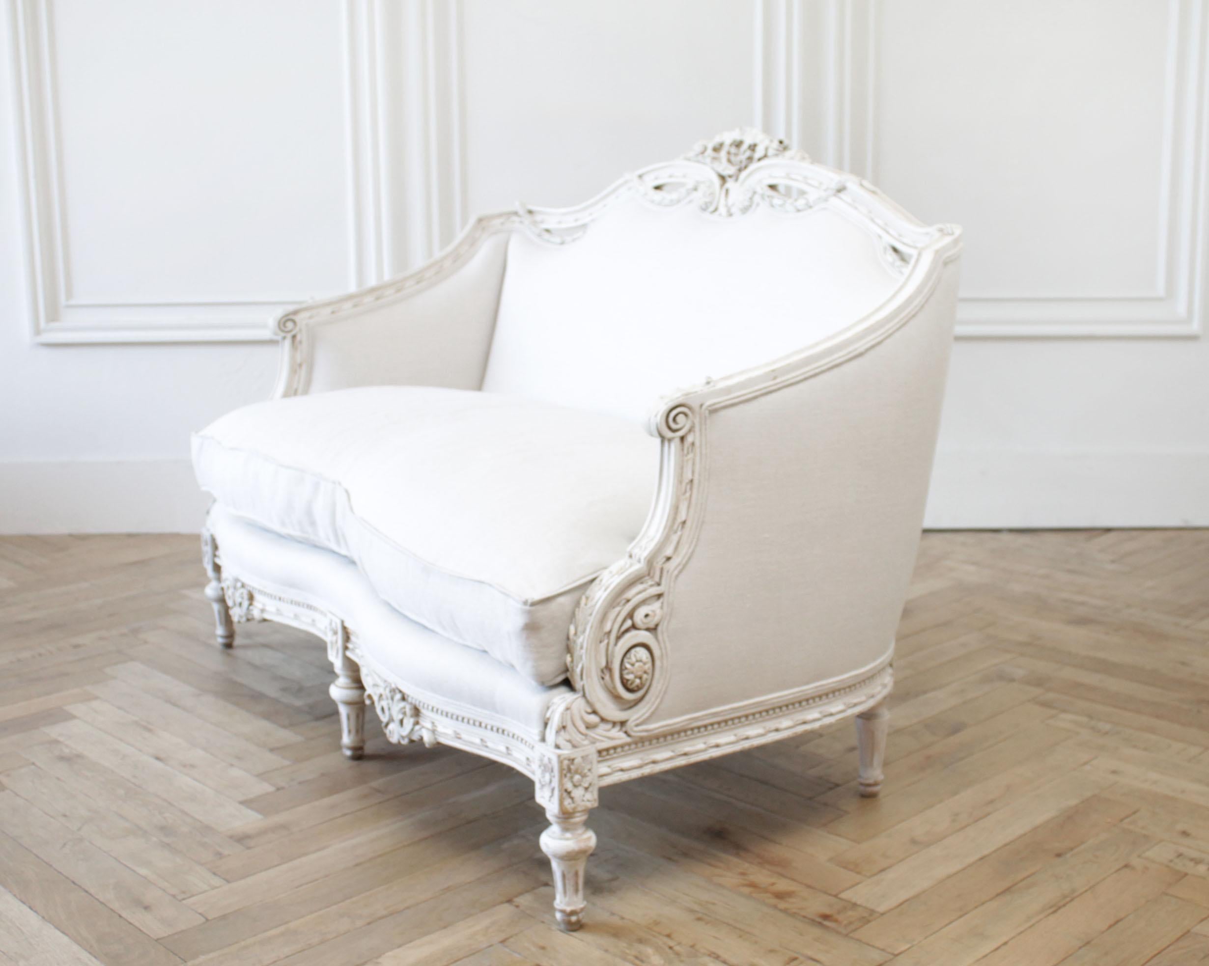 20th century painted carved Louis XVI style settee upholstered in Irish linen
Beautiful settee has an original painted finish that has been patina'd by our finisher to give a little more age and enhance the carvings. It is a creamy white color,