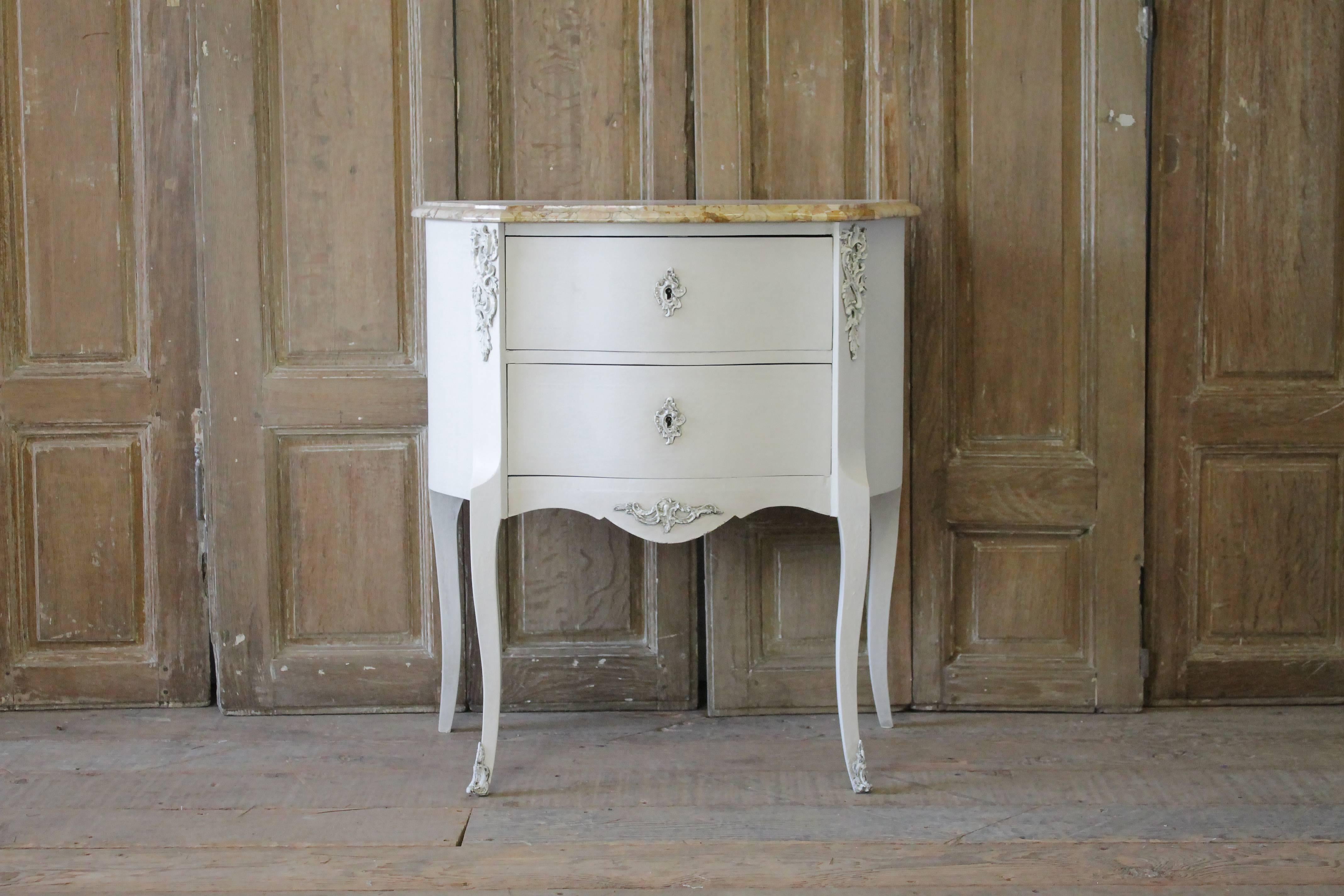 20th century painted French Louis XV style commode with marble top
Original working locking key and tassel, drawers open and close with ease. Drawers are finished with a dovetail construction. Original bronze-mounted ormolus and escutcheons painted