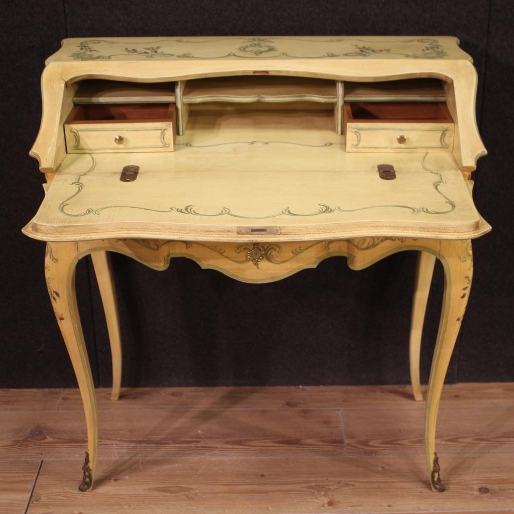 Venetian bureau from the second half of the 20th century. Beautifully designed furniture, pleasantly lacquered and hand painted with floral decorations. High leg bureau equipped with an external drawer plus a fall front. Interior complete with two