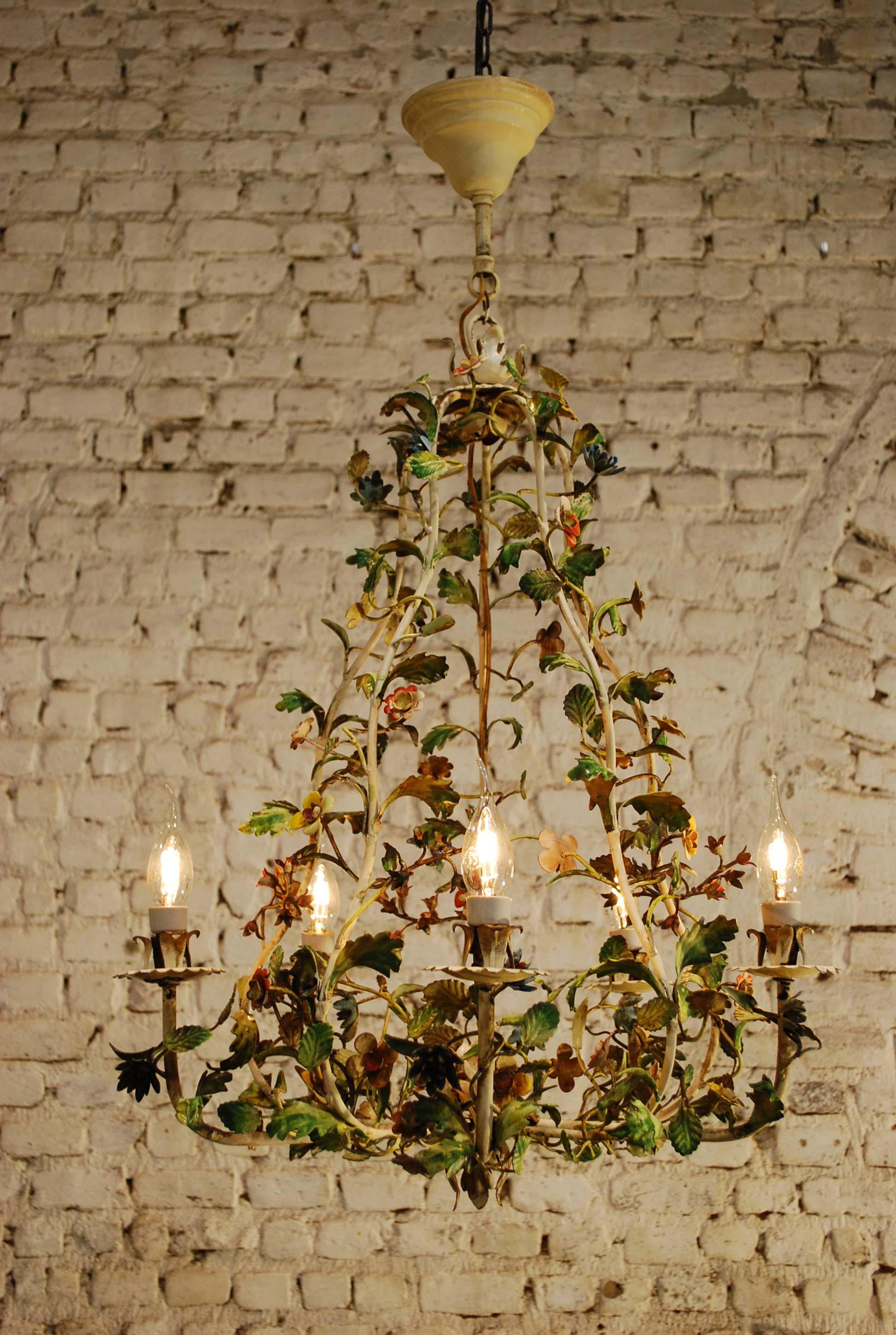 A beautiful hand-wrought iron chandelier with multi-colored paint.
It was made in Italy circa 1900. This five-light chandelier features many different flowers and leaves and has a wonderful aged paint and patina over it. The sockets and wiring are