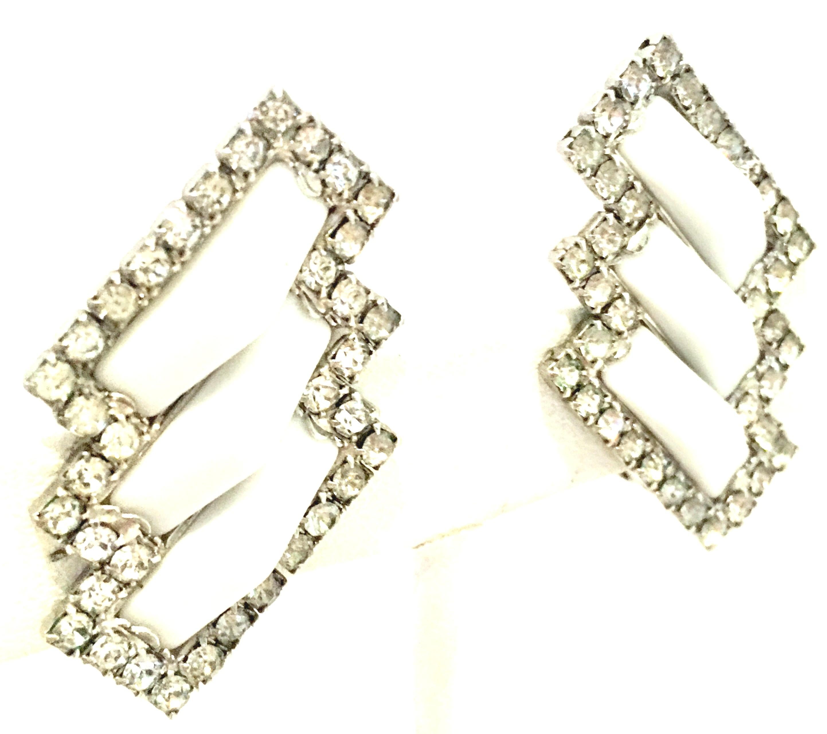 20th Century Pair Of Art Deco Style Silver, Austrian Crystal & White Lucite Dimensional Earrings. These unique clip style earrings feature silver plate pave set colorless brilliant cut and faceted Austrian crystal stones with inset white dimensional