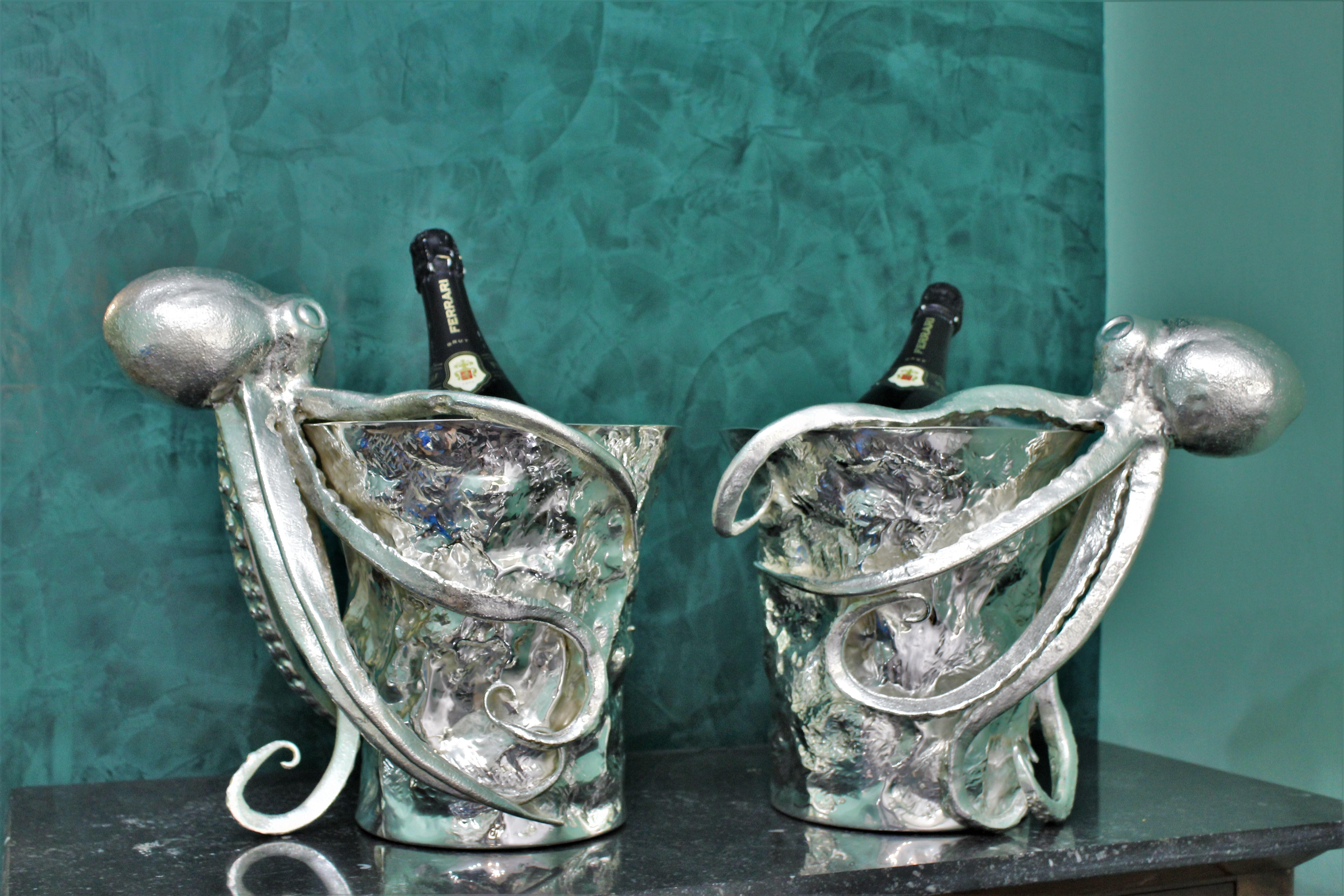 Pair of artistic silver wine coolers, realized in Italy, circa 1930s.

Handmade, embossed and engraved by hand. 

Circular shaped. The main body of the wine cooler is embossed and look like rocks.

Around the rock the octopus is attached in a