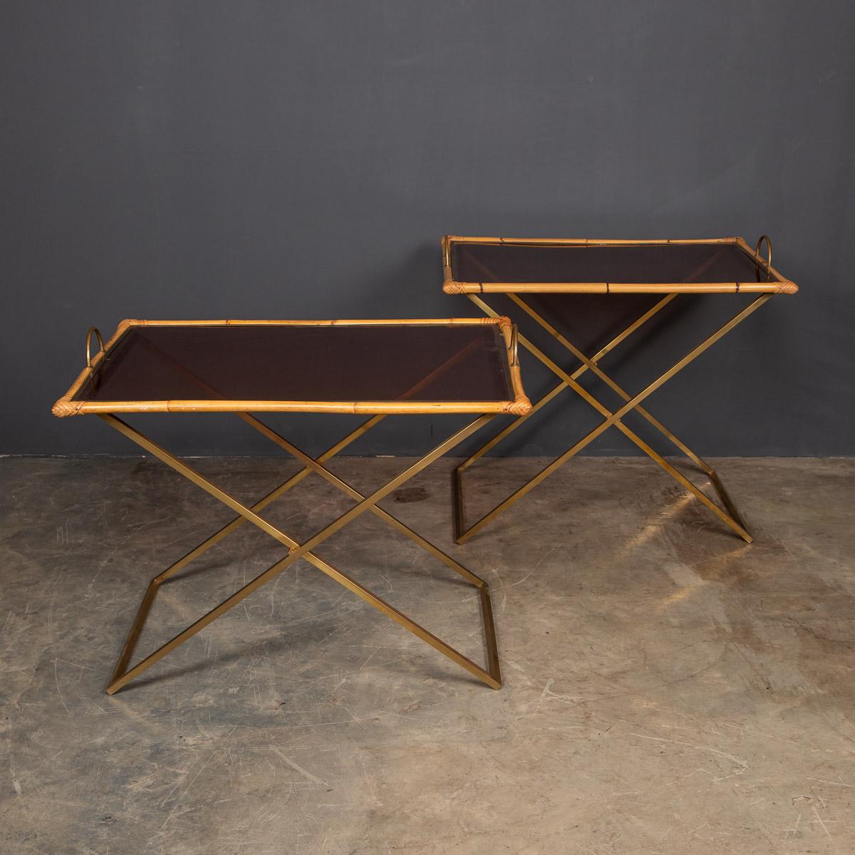 Stylish 20th century pair of bamboo and brass butler tray tables of slightly different sizes. These tray tables have a removable smoked perspex tray with a brass frame covered with bamboo and brass handles, resting on a brass X-frame
