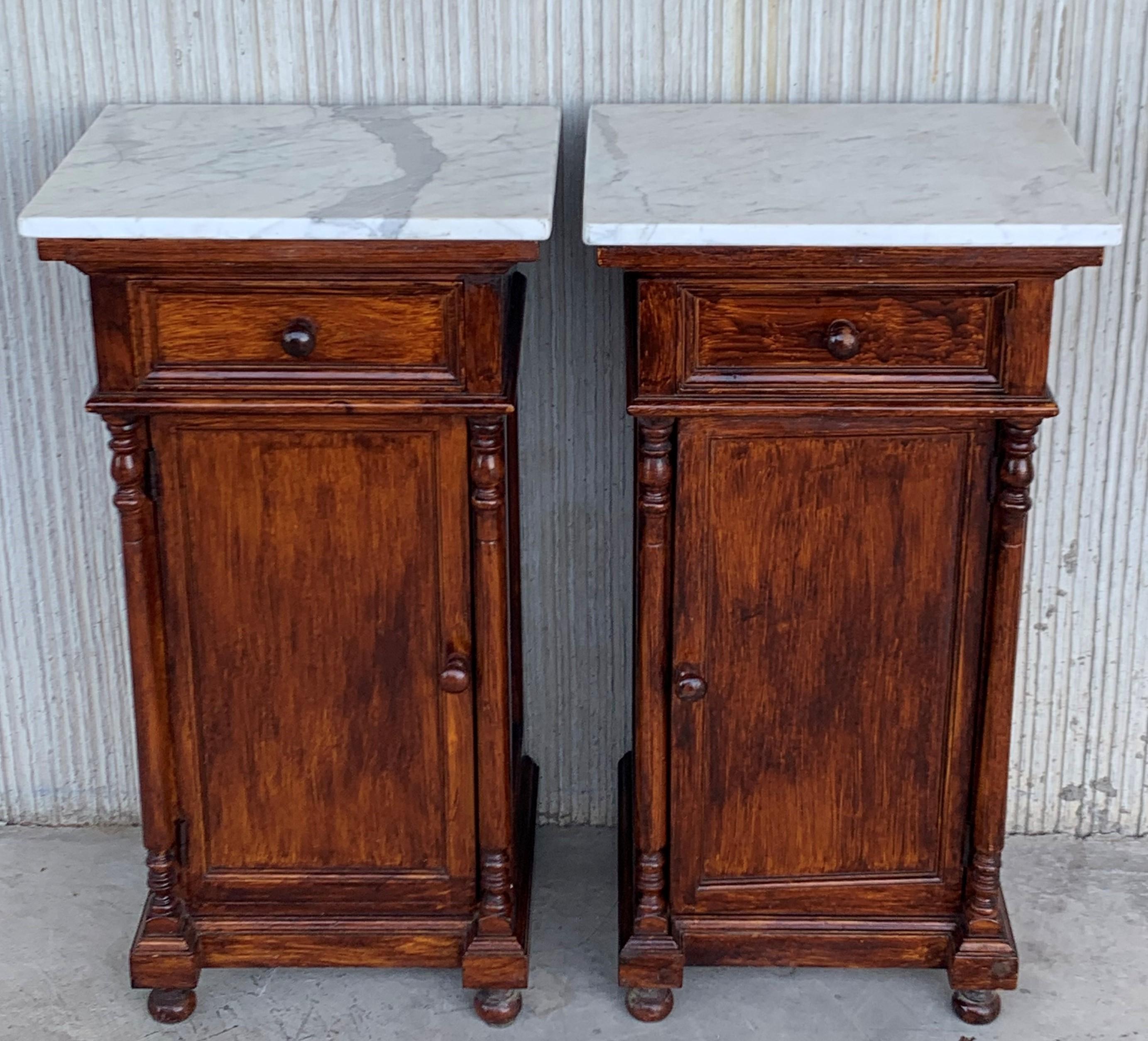 Pair of antique Biedermeier style bedside cabinets, late 19th-early 20th century, possibly French or Spanish, each in oblong rectangular form, the marble atop a fabric-lined surface, over a conforming case fitted with a single drawer over a cabinet