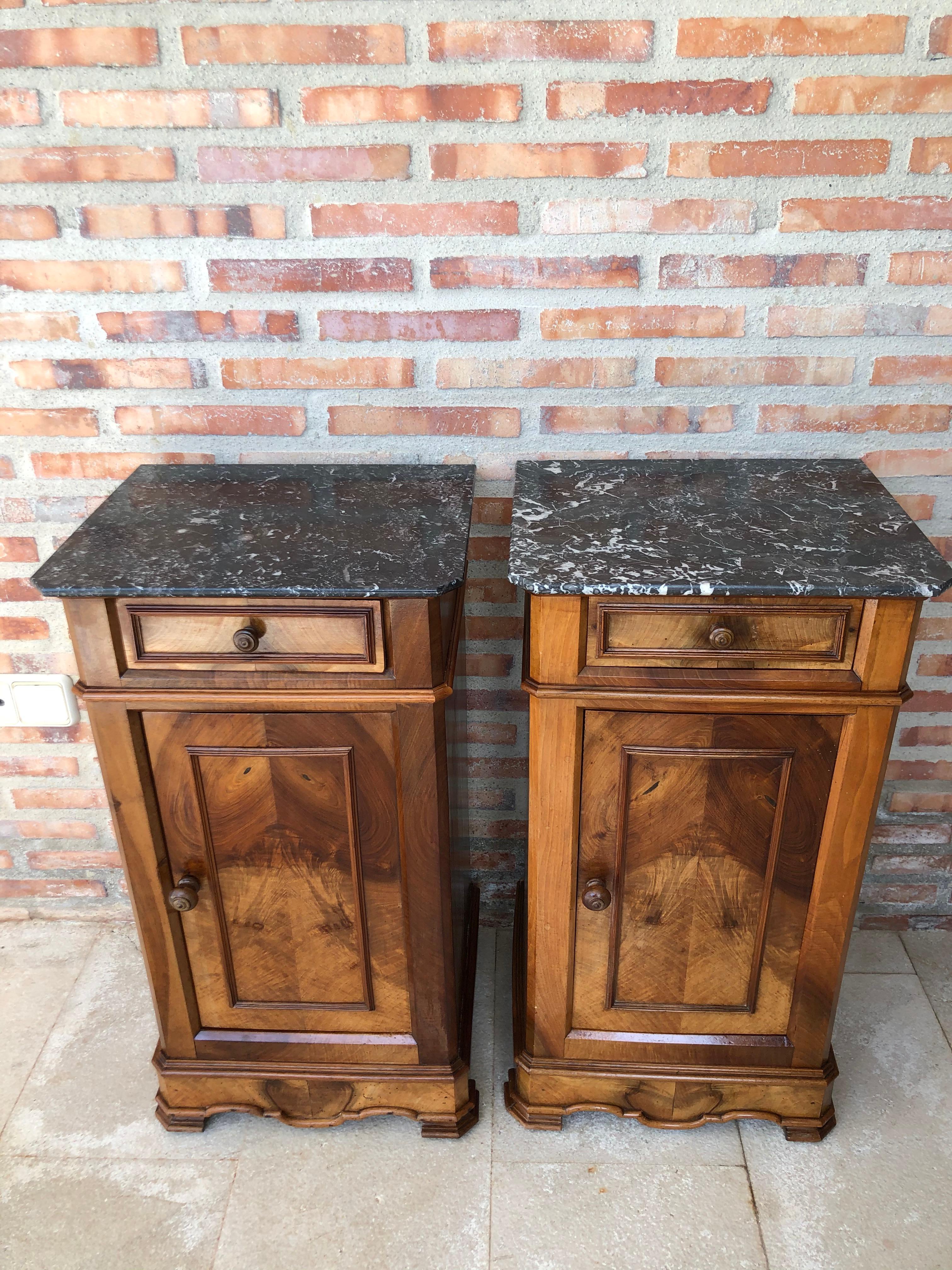 Pair of antique Biedermeier style bedside cabinets, late 19th-early 20th century, possibly French or Spanish, each in oblong rectangular form, the marble atop a fabric-lined surface, over a conforming case fitted with a single drawer over a cabinet