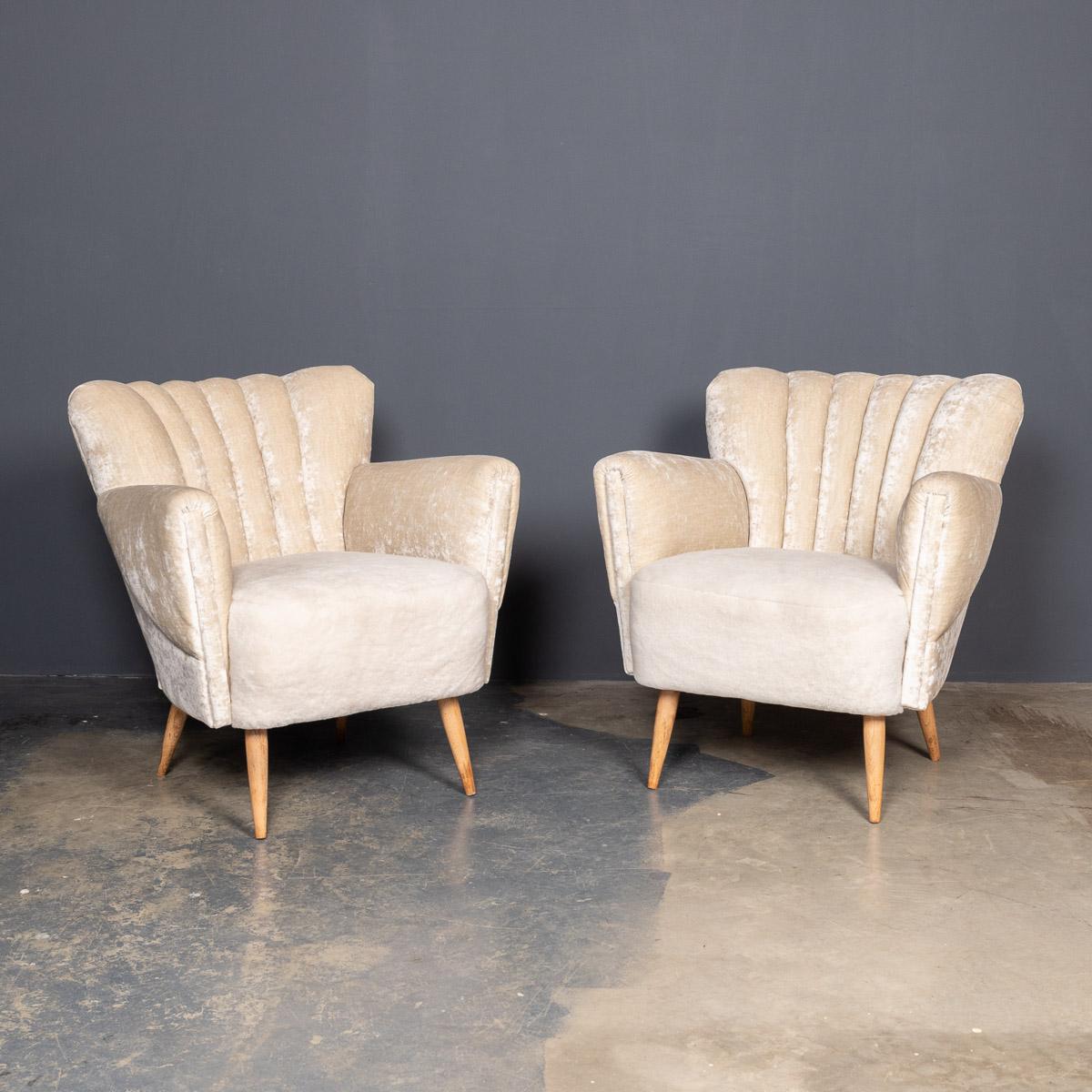 Elegant mid-20th century pair of boudoir occasional chairs with a sweeping shell shaped back. These pieces have been reupholstered in cream crushed velvet, with a soft sheepskin seat.

Measures: Height: 76cm
Depth: 60cm
Width: 74cm.