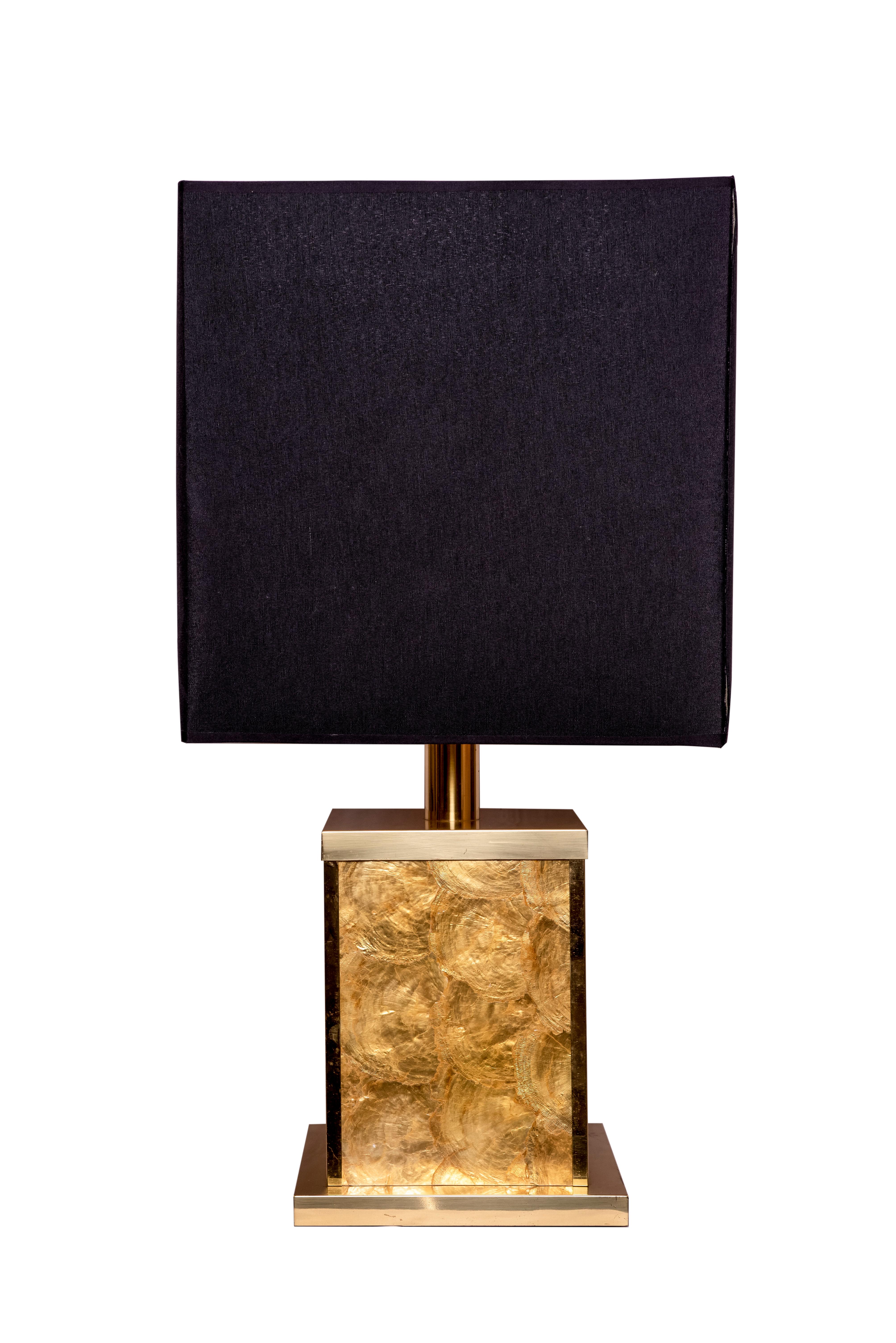 20th century pair of capiz shell table lamps with a brass base and top.
Both with black cotton and gold lampshades.