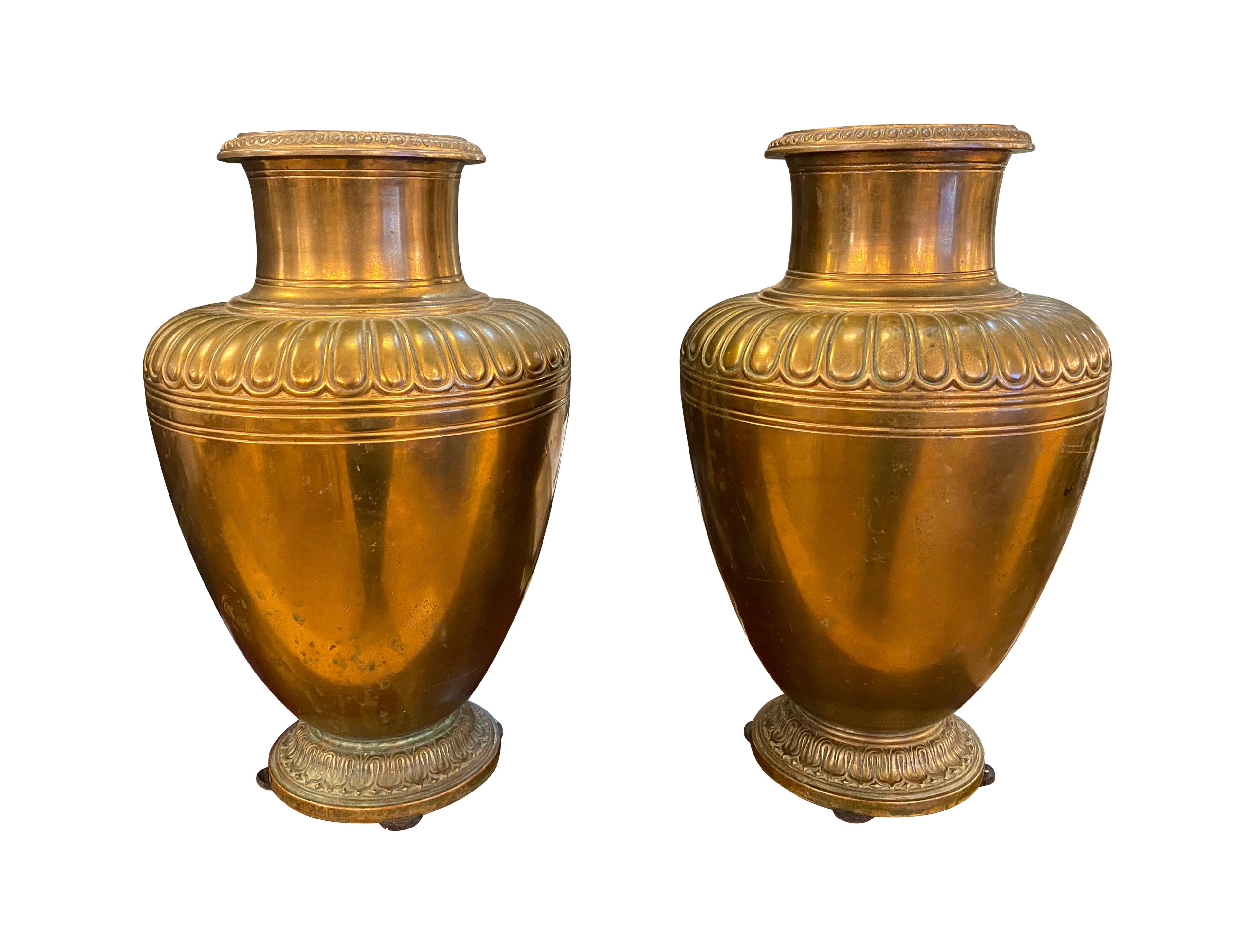 Tiffany bronze urns with simple egg and dart detailing from the 20th century. This can be seen at our 2420 Broadway location on the upper west side in Manhattan.