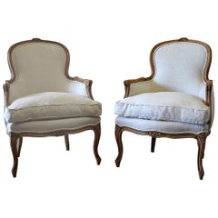 20th Century Pair of Carved & Upholstered Louis XV Style Bergère Chairs in Linen