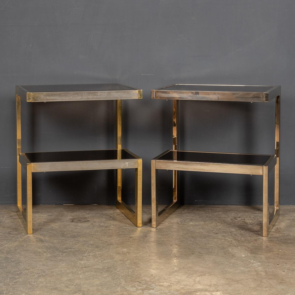 A pair of small chrome G tables by Belgo, the lower shelf with mirrored glass and the upper surface in classic smoked glass. A wonderful addition to any interior, that will undoubtedly add style and sophistication.

CONDITION
In good condition -