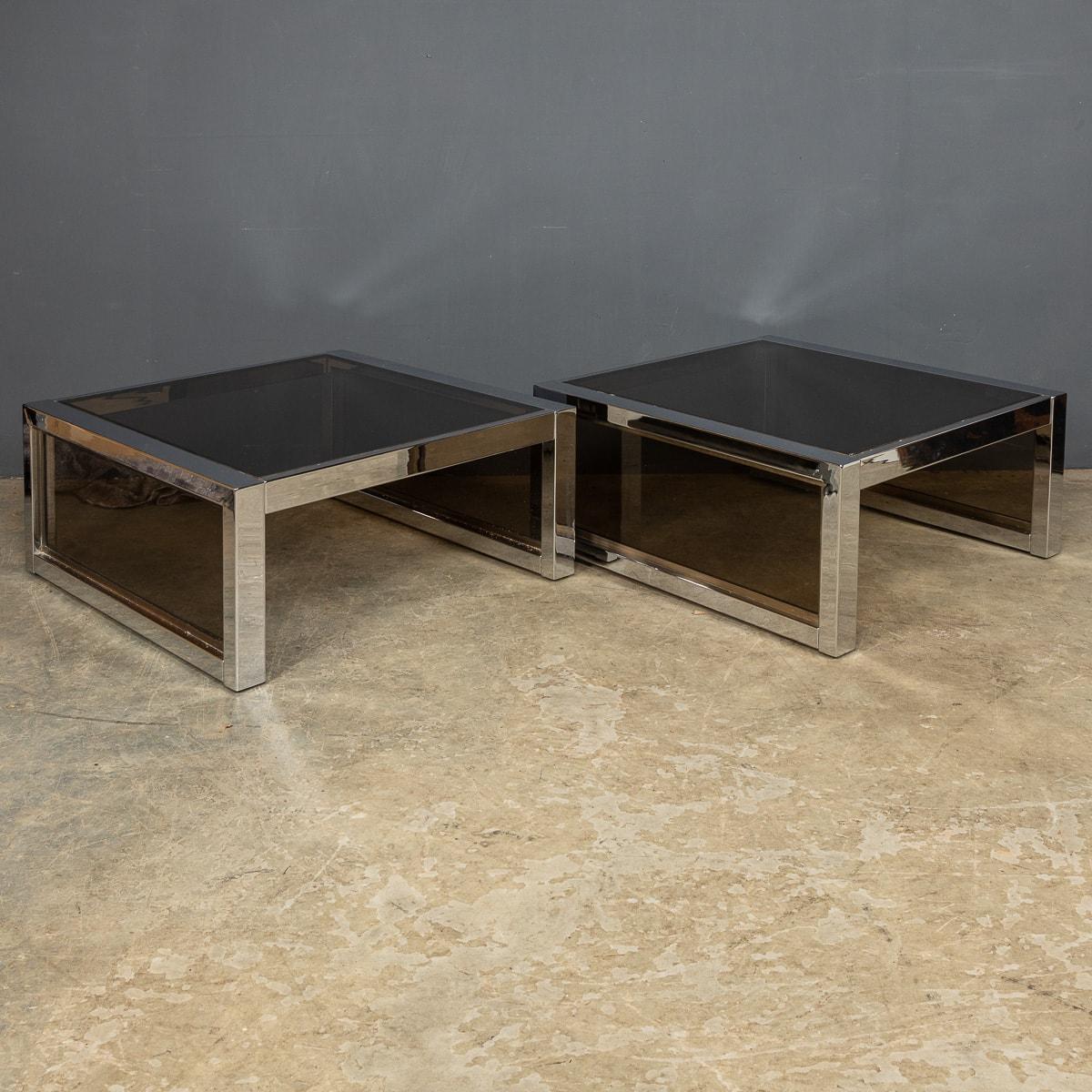 A pair of 20th century polished chrome and smoked glass side tables. A wonderful addition to any interior, that will undoubtedly add style and sophistication.

CONDITION
In Good Condition - wear consistent with age, (please refer to