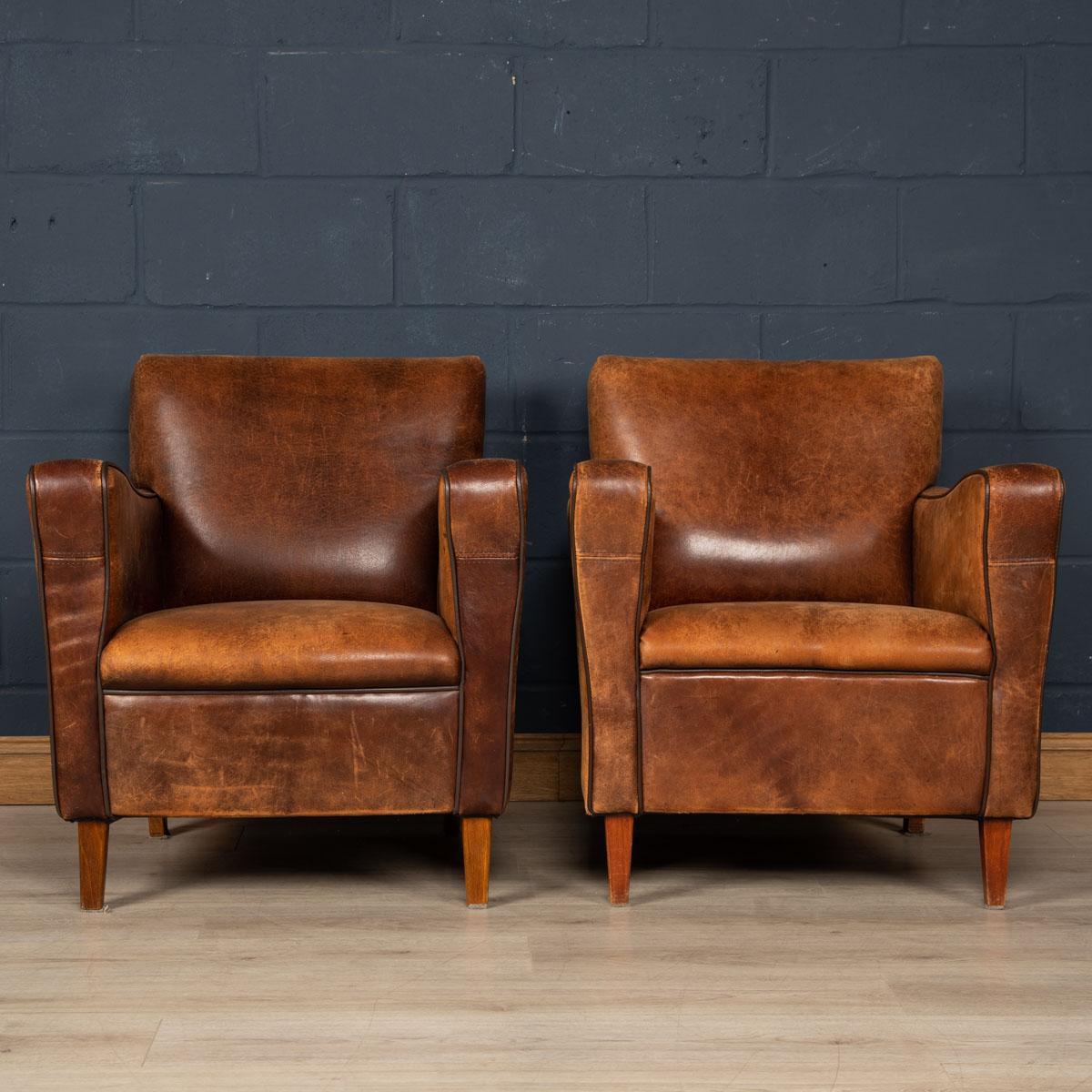 Showing superb patina and colour, this wonderful pair of club chairs were hand upholstered sheepskin leather in Holland by the finest craftsmen in the latter part of the 20th century.

CONDITION
In good condition - some wear consistent with