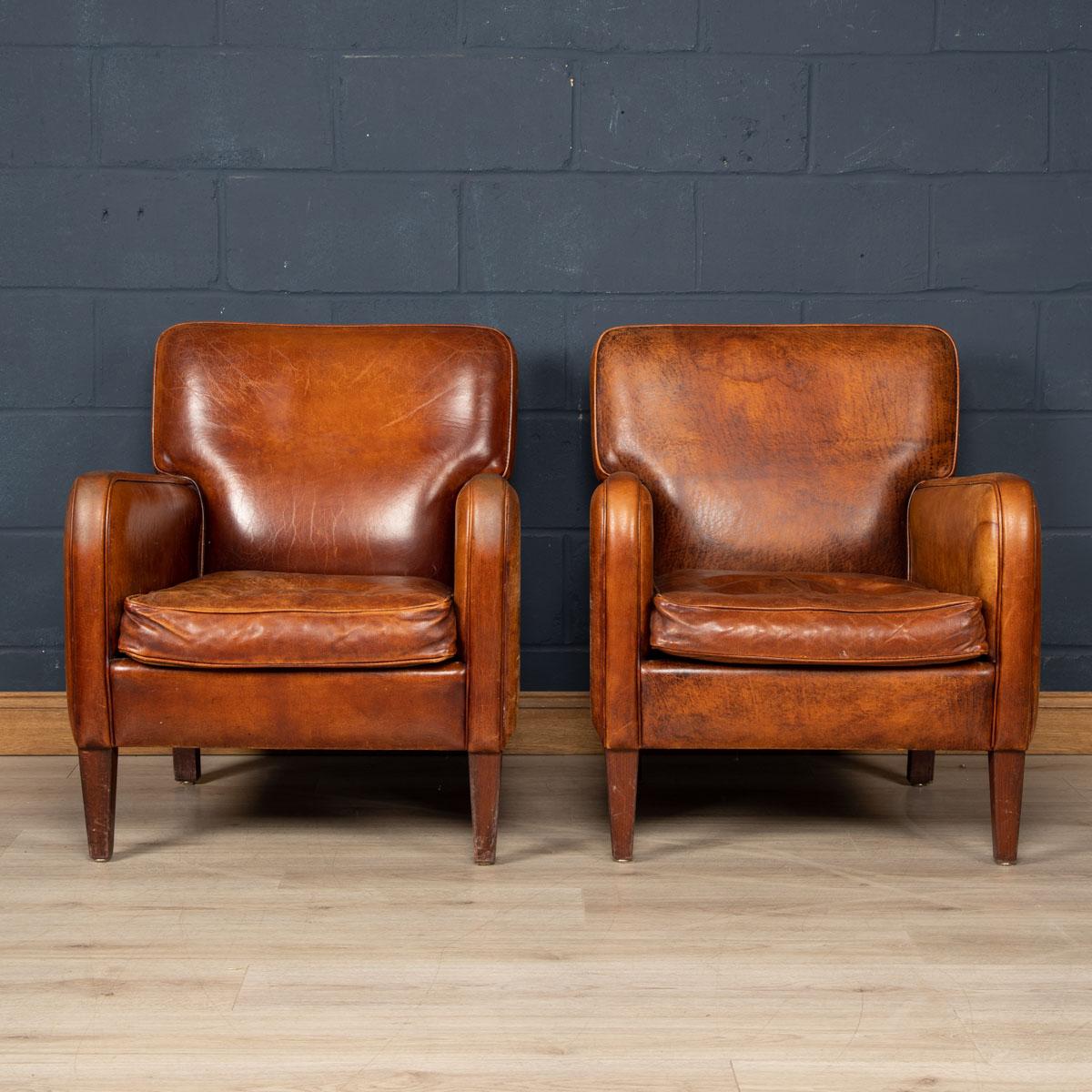 Showing superb patina and colour, this wonderful pair of club chairs were hand upholstered sheepskin leather in Holland by the finest craftsmen in the latter part of the 20th century.

Condition
In Good Condition - some wear consistent with