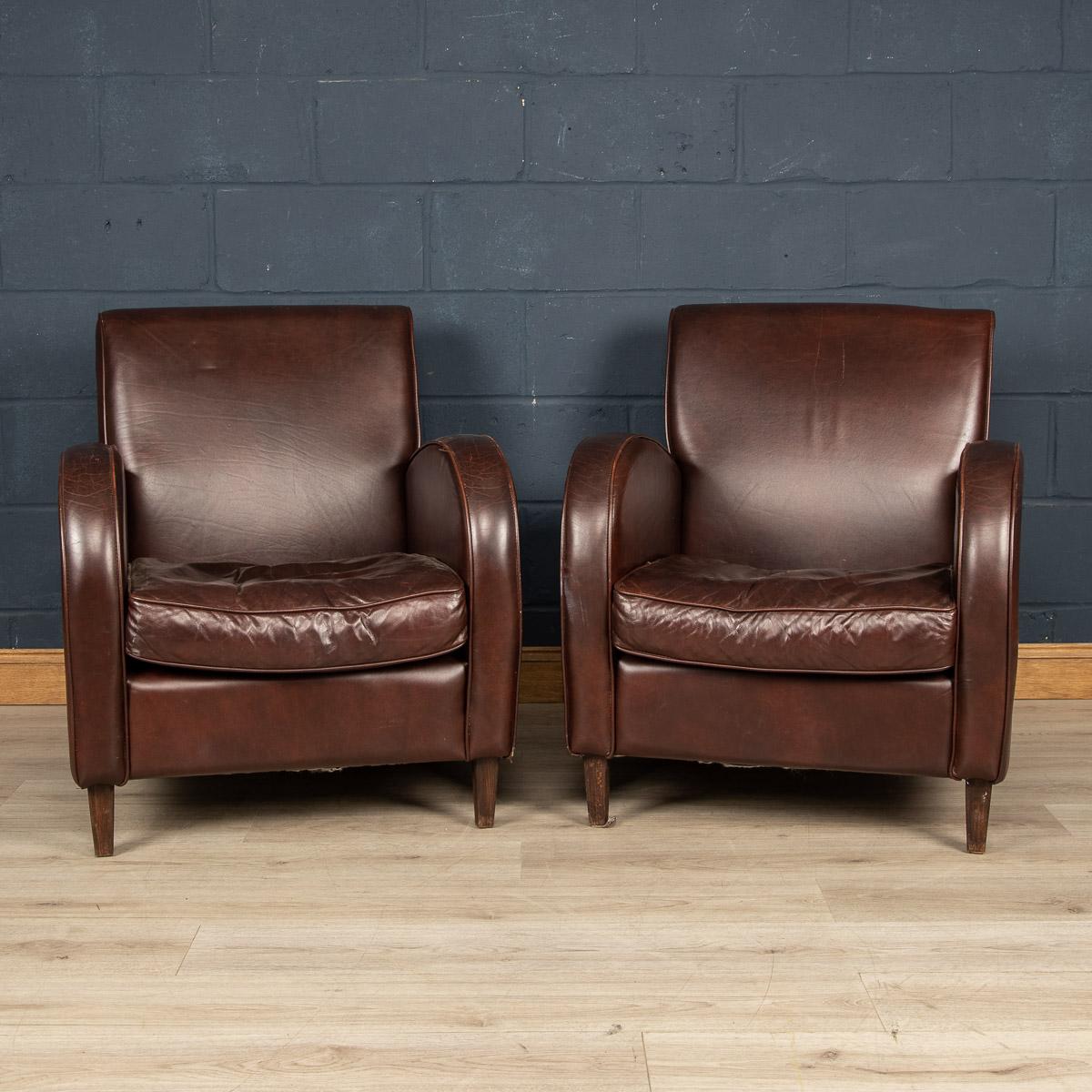A wonderful pair of leather wing back armchairs. Dating to the latter part of the 20th century these chairs have been realised by the finest Dutch craftsmen, the solid wood frame upholstered in superb quality honey coloured sheepskin leather which