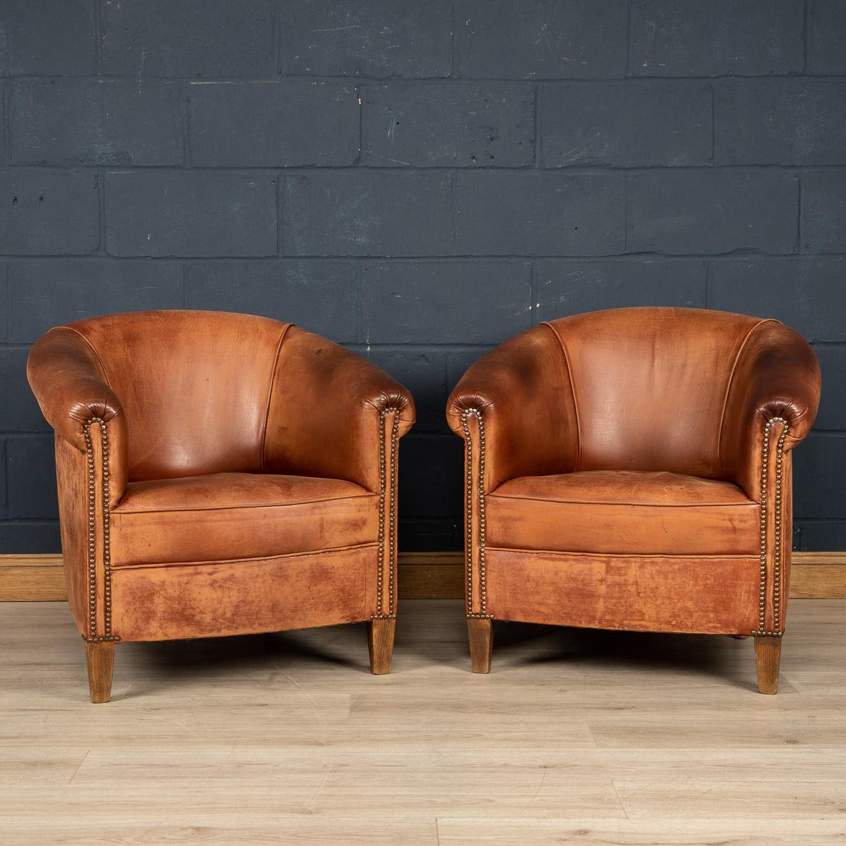 Showing superb patina and colour, this wonderful pair of club chairs were hand upholstered sheepskin leather in Holland by the finest craftsmen in the latter part of the 20th century.

Condition
In good condition - some wear consistent with