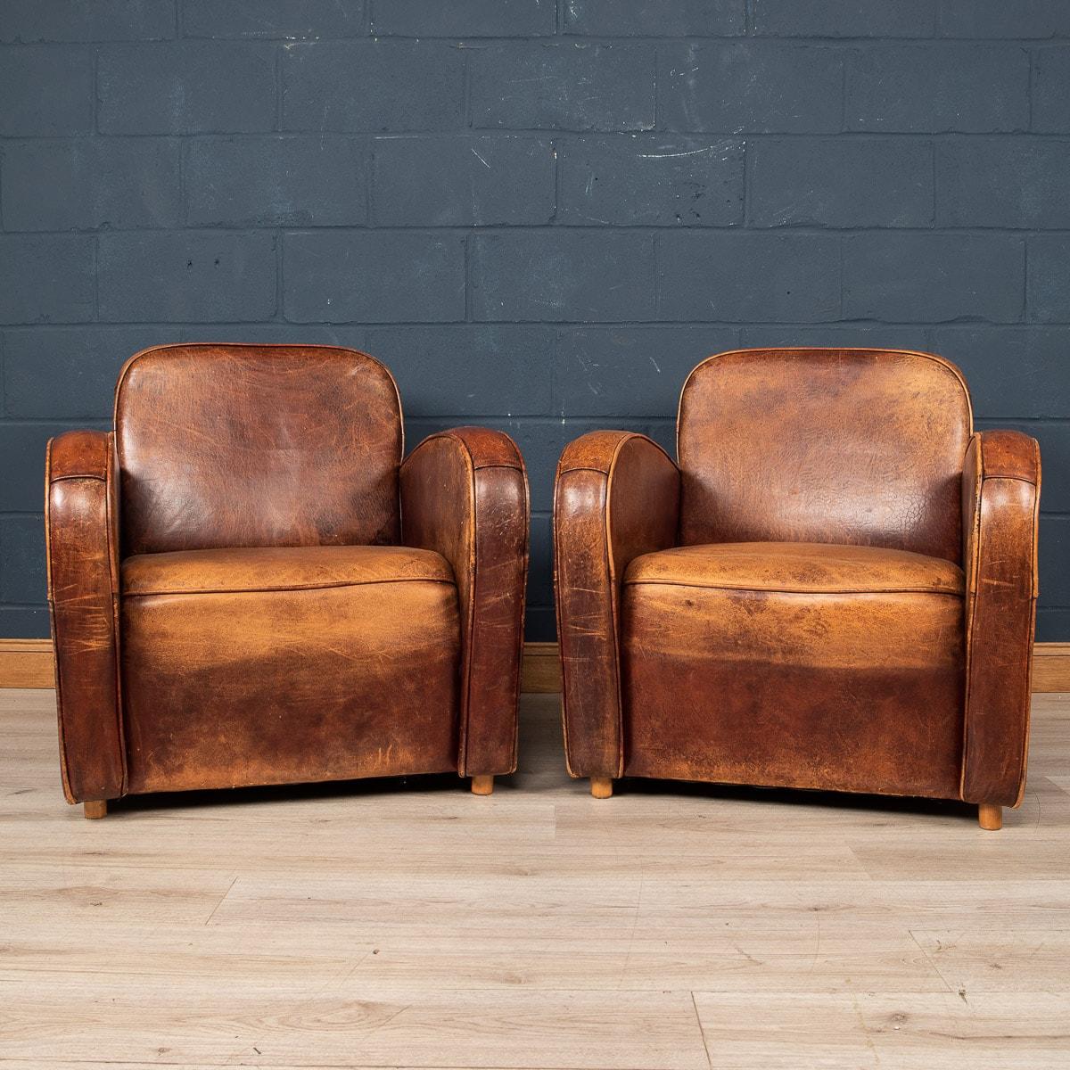 Showing superb patina and colour, this wonderful pair of club chairs were hand upholstered sheepskin leather in Holland by the finest craftsmen in the latter part of the 20th century.
The design and craftsmanship of sheep leather furniture was