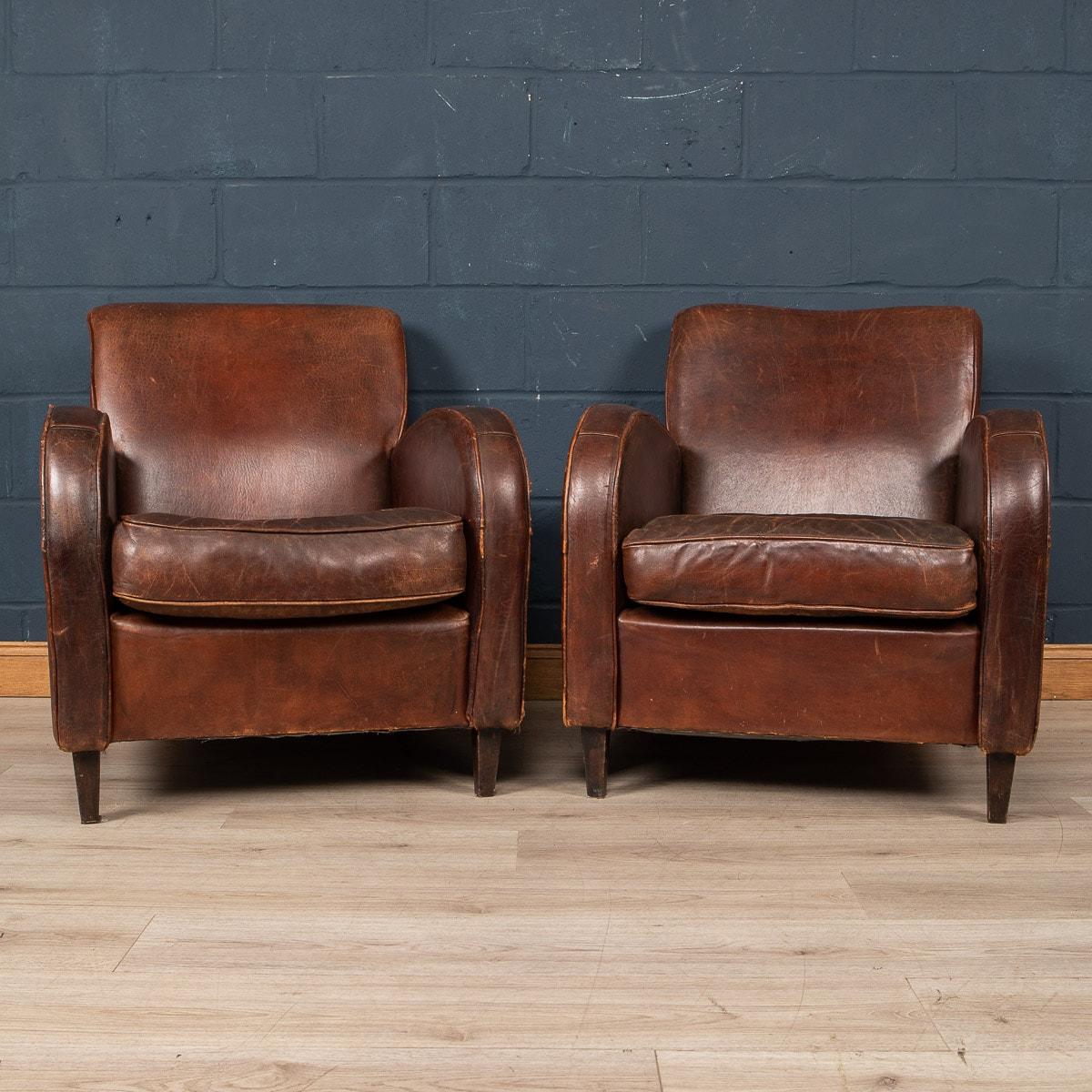 Showing superb patina and colour, this wonderful pair of club chairs were hand upholstered sheepskin leather in Holland by the finest craftsmen in the latter part of the 20th century.

The design and craftsmanship of sheep leather furniture was