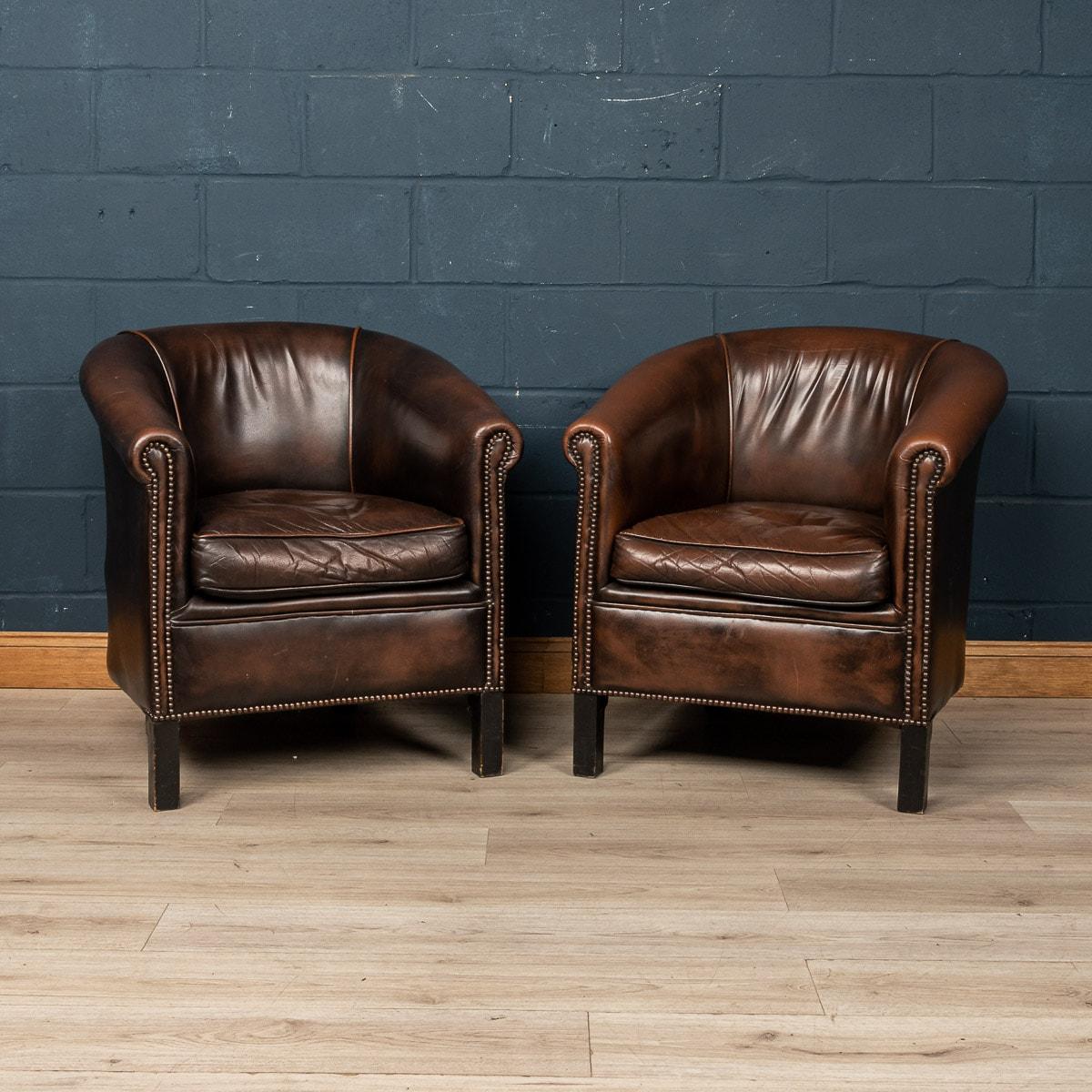 Showing superb patina and colour, this wonderful pair of club chairs were hand upholstered sheepskin leather in Holland by the finest craftsmen in the latter part of the 20th century.

CONDITION
In Good Condition - Some wear consistent with