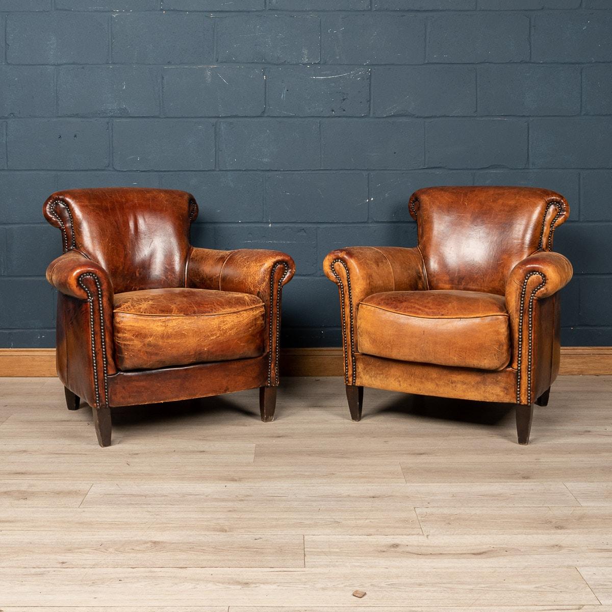 Showing superb patina and colour, this wonderful pair of club chairs were hand upholstered sheepskin leather in Holland by the finest craftsmen in the latter part of the 20th century.

CONDITION
In Good Condition - Some wear consistent with