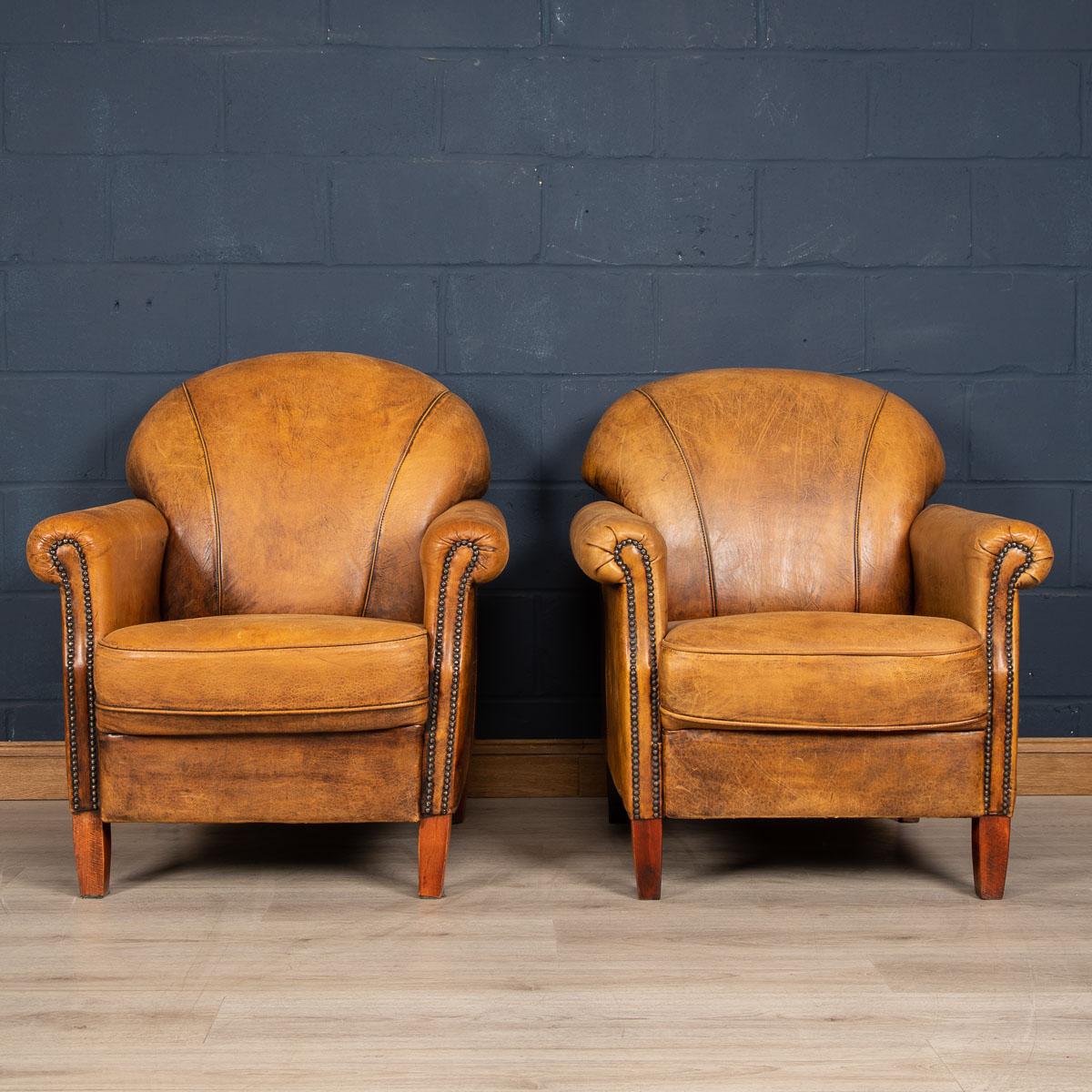 Showing superb patina and color, this wonderful pair of club chairs were hand upholstered sheepskin leather in Holland by the finest craftsmen. Fantastic look for any interior, both modern and traditional.

Please note that our interior pieces are