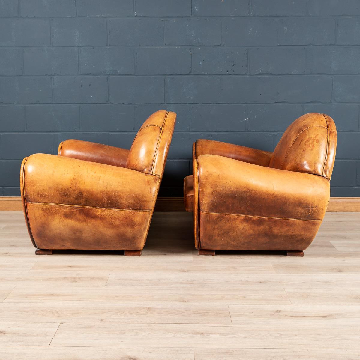 A lovely pair of sheepskin leather armchairs dating to the latter part of the 20th century, this wonderful pair of club chairs were hand upholstered in sheepskin leather in Holland by the finest craftsmen. An unusual Art Deco style model, inspired