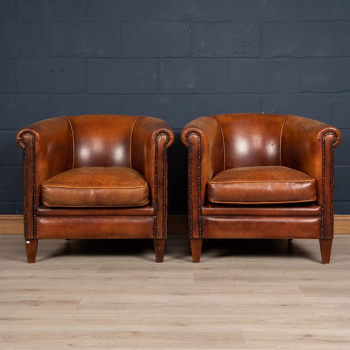 Showing superb patina and color, this wonderful pair of club chairs were hand upholstered sheepskin leather in Holland by the finest craftsmen. Fantastic look for any interior, both modern and traditional.

Please note that our interior pieces are