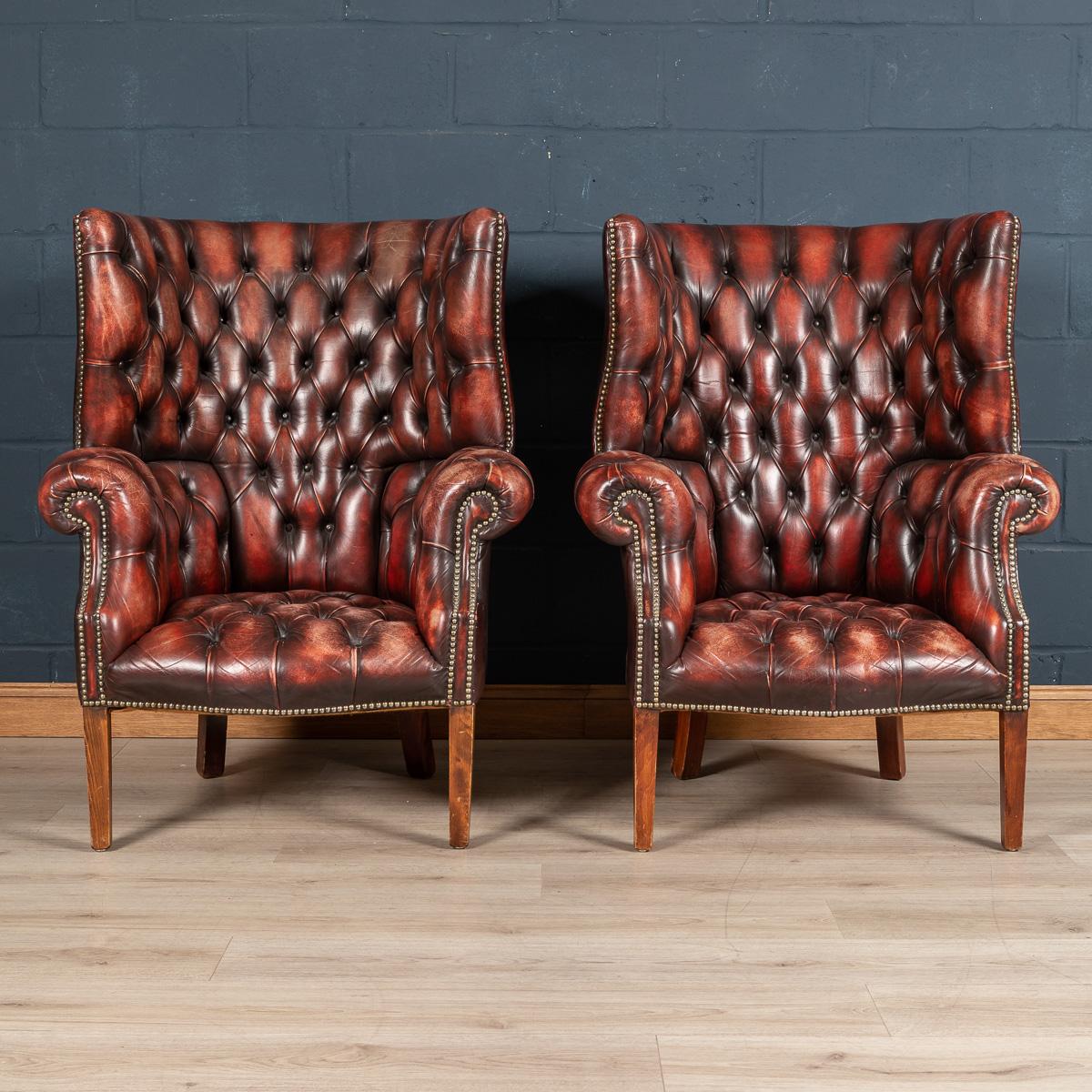 A truly excellent pair of barrel back leather armchairs. The characteristic of a barrel back chair is a high back, semi circular back rest. This particular pair dates back to around the second half the last century. These is some discolouration to