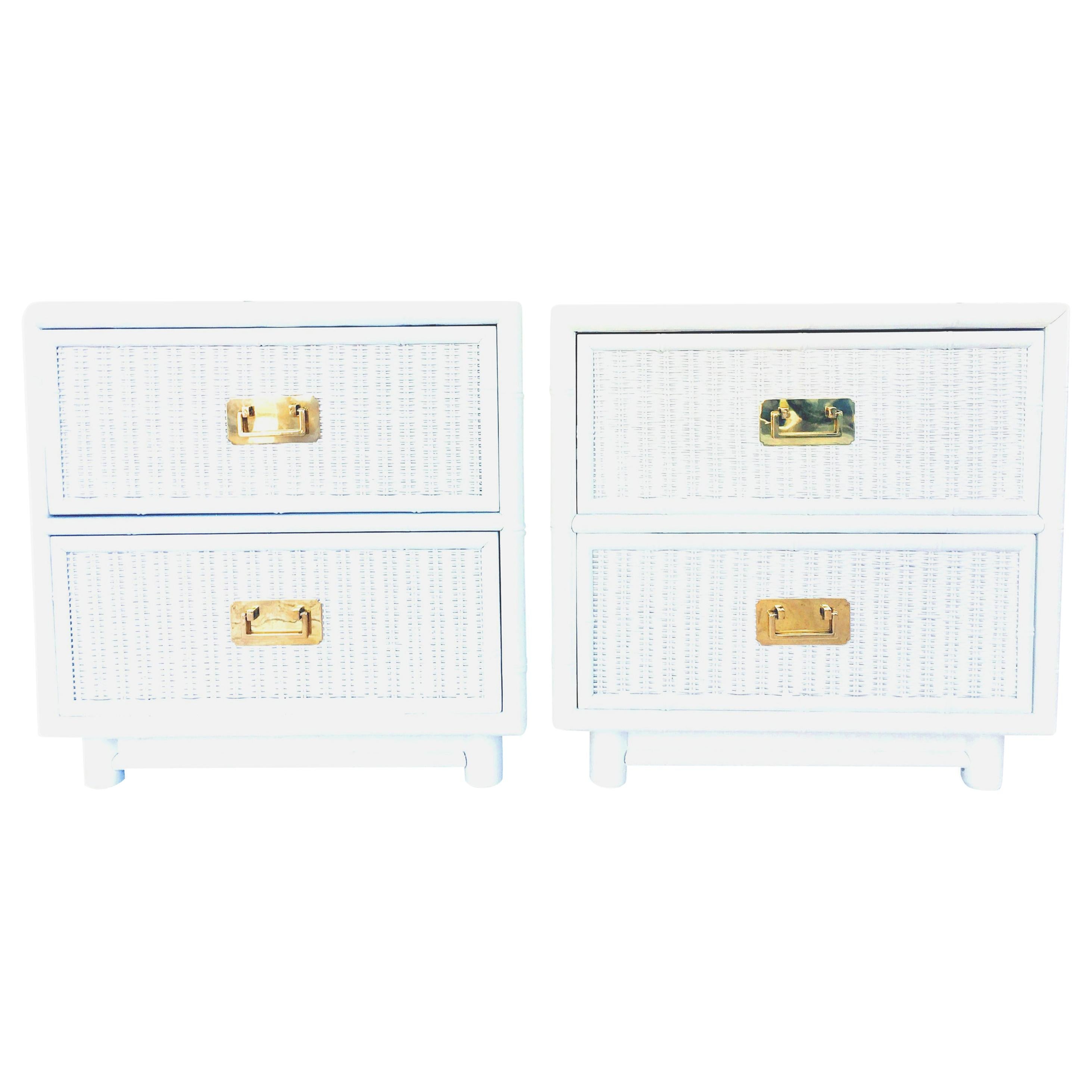 20th century pair of Campaign style white lacquered wood, woven wicker and gilt brass faux bamboo side tables or nightstands. These finely crafted, pristine tables feature a faux bamboo wood frame, woven wicker detail maple tongue and groove drawers