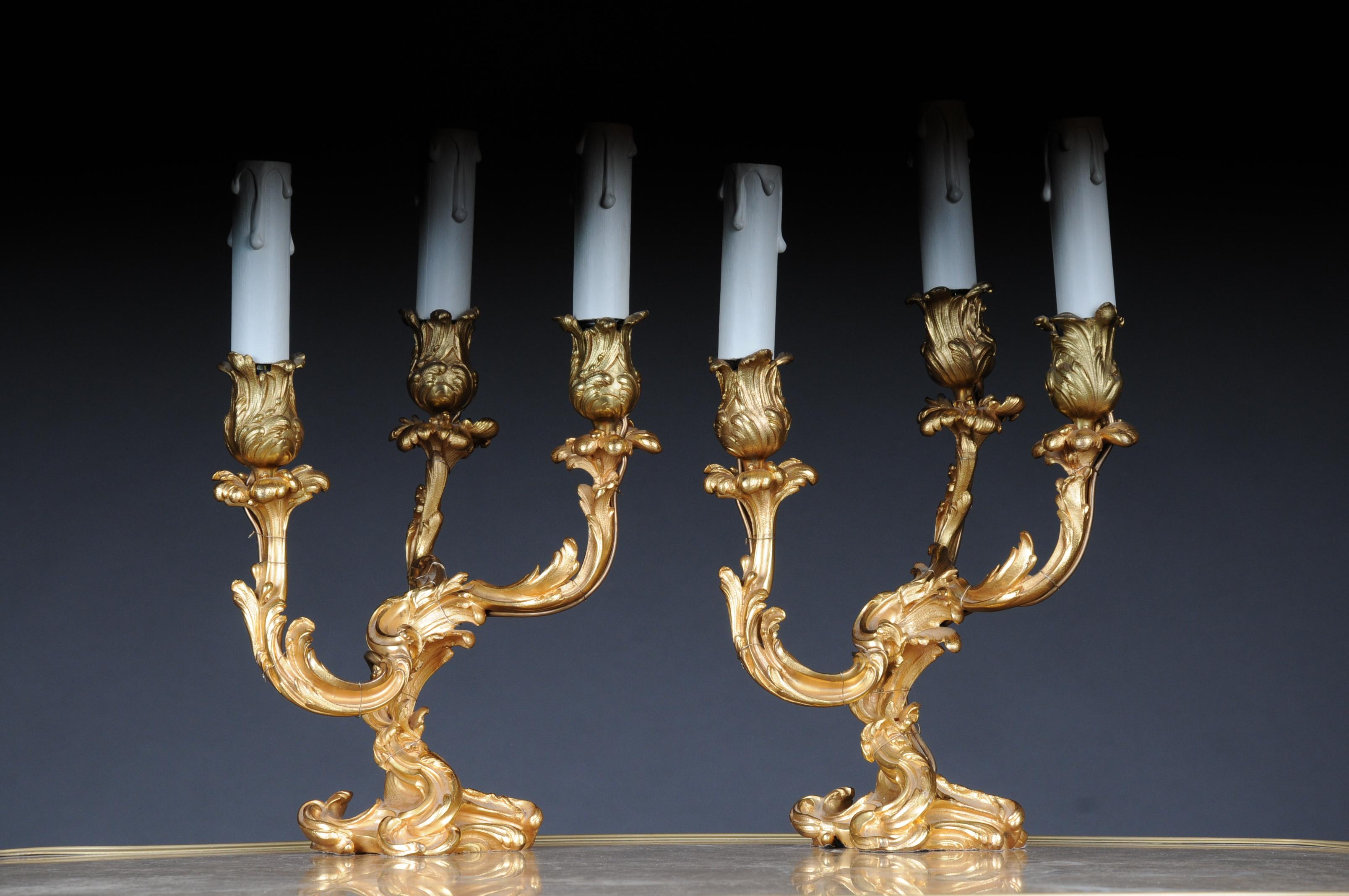 20th century Pair of French candle lamps bronze, electrified. 
Richly carved body, solid bronze gilded. Each 3-flame arms electrified. Extremely decorative and high quality workmanship. 20th century

(F-99)