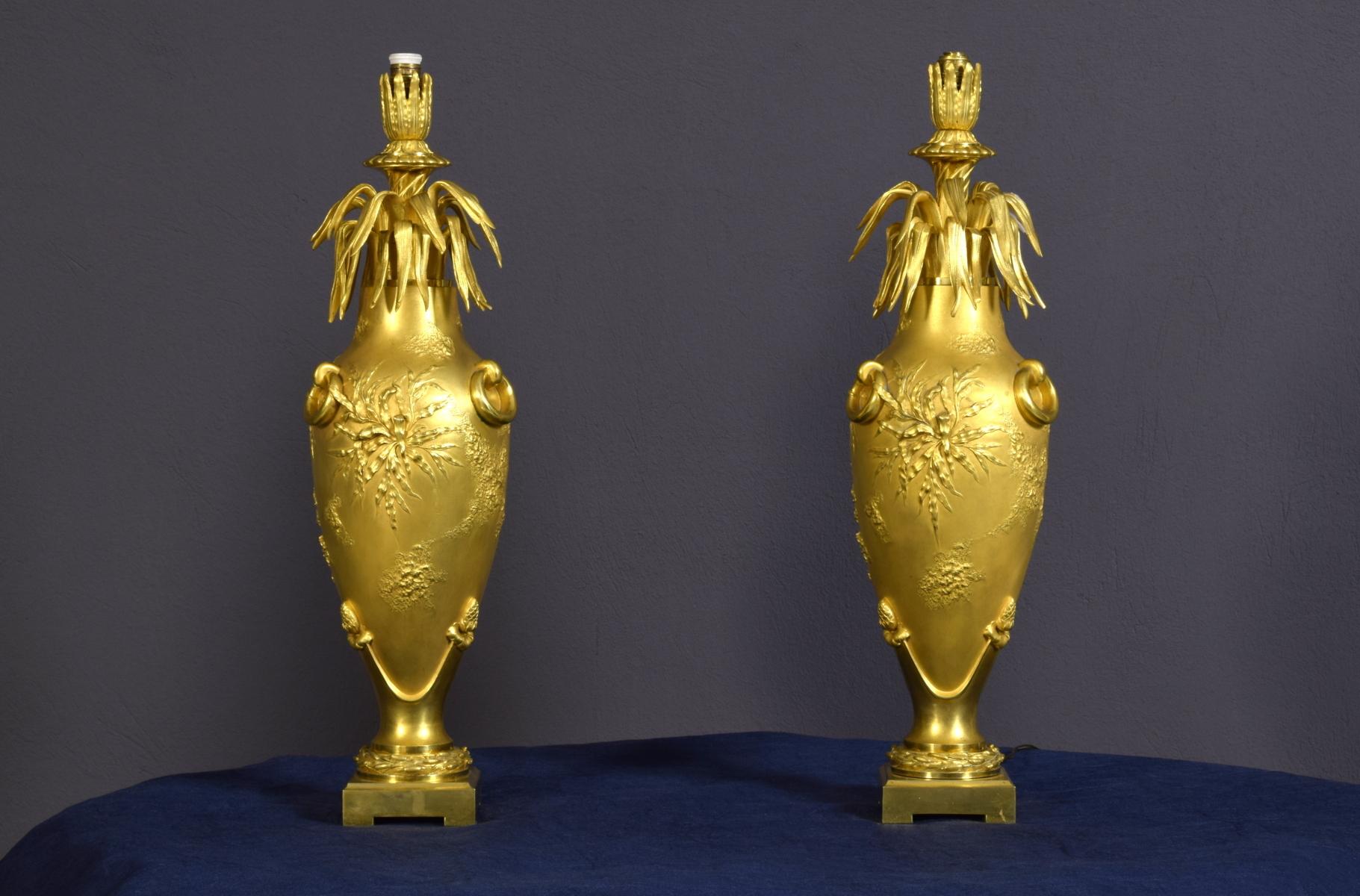 20th century pair of French chiselled and gilt bronze lamps
Measurements: cm height 50 x diameter 13; base 9 x 9 cm. With the lampshade the lamp is 73 cm high

The particular pair of lamps was made in finely chiselled and gilt bronze in France at