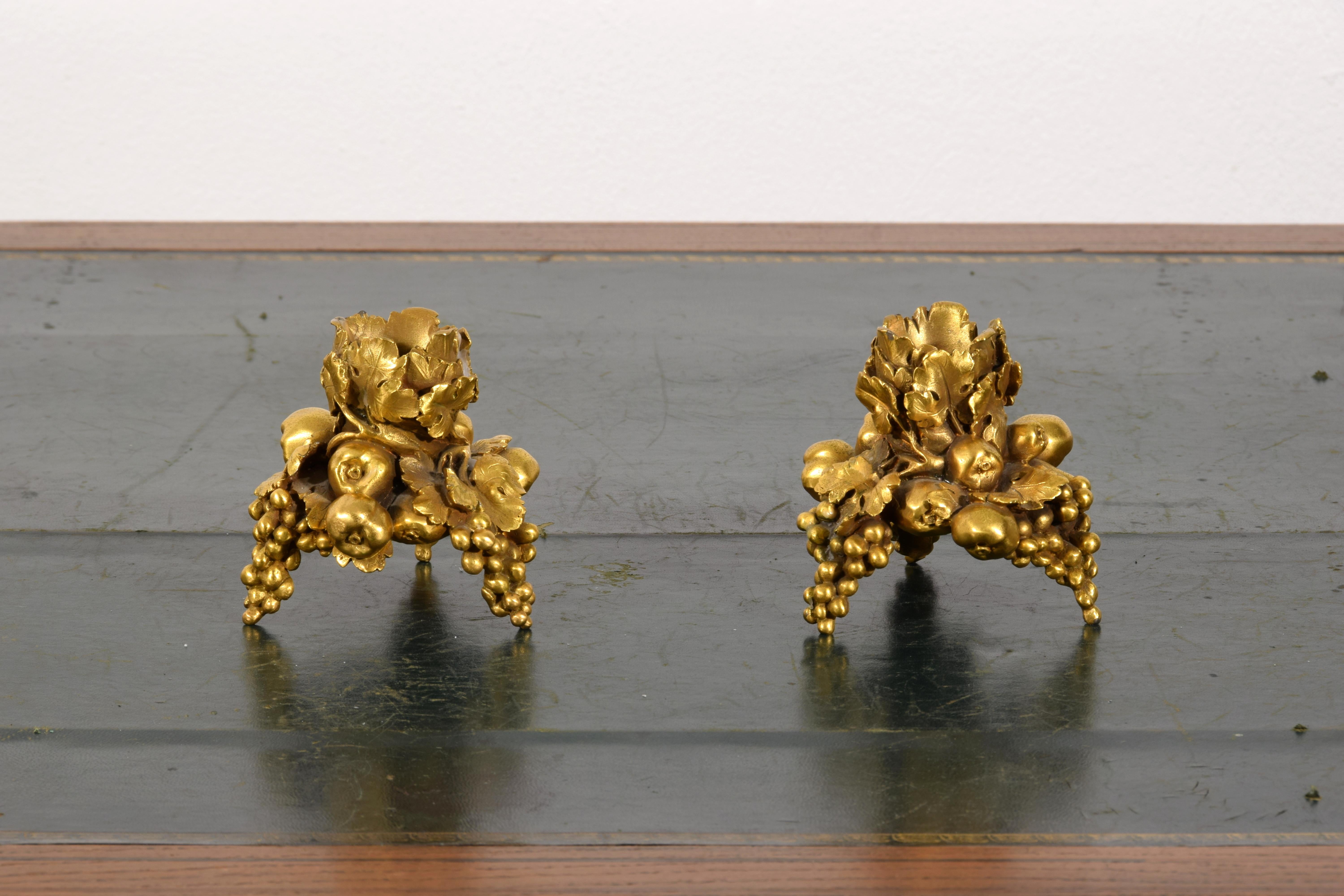 20th century, Pair of French Gilt Bronze Candlesticks 

The pair of candlesticks, made in the twentieth century, is in gilded bronze.
The structure of each candlestick consists of plant and fruit elements: it rests on three bunches of grapes on