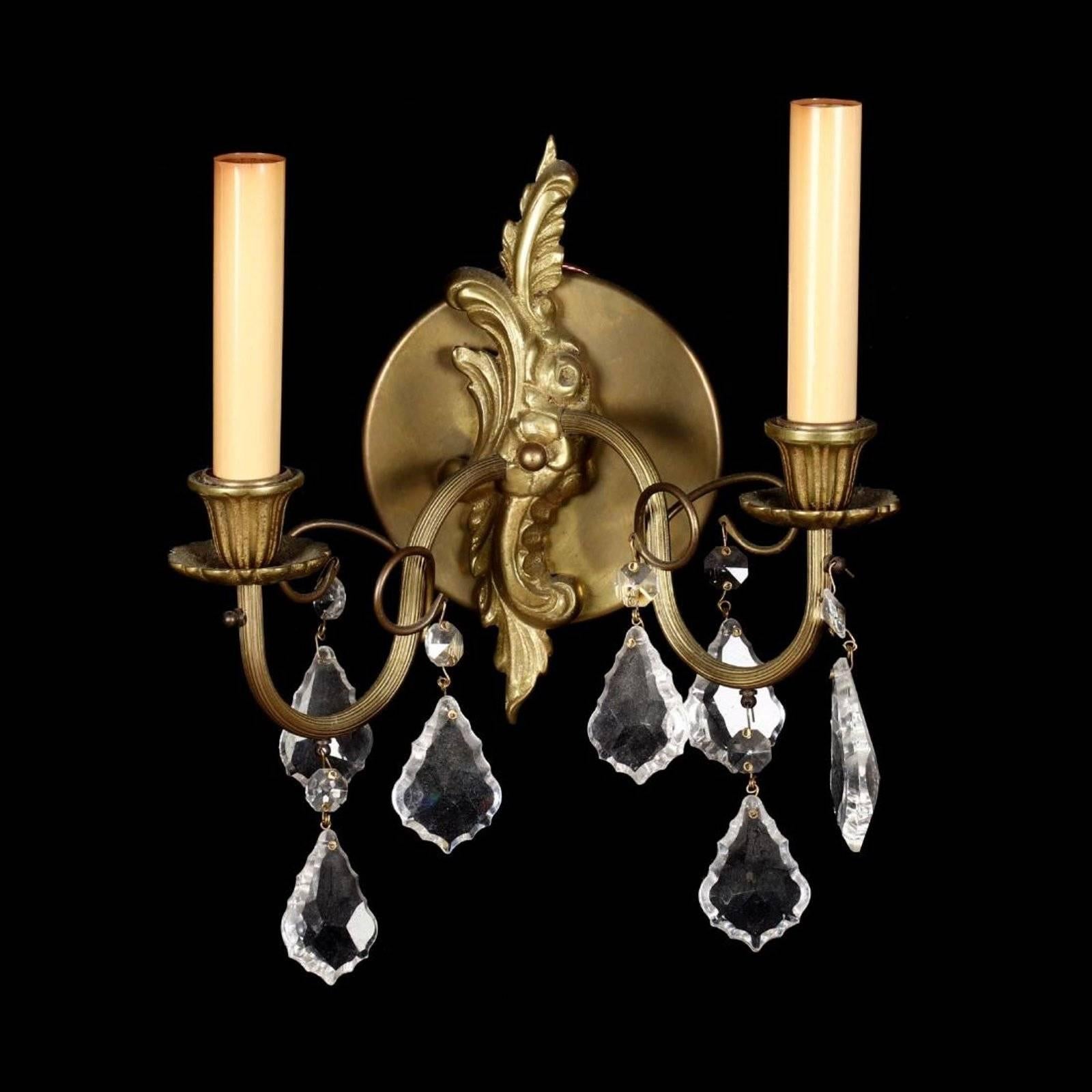 Mid-20th century pair of French Rococo style drop prism wall sconces with scrolled arms and cut glass drop prisms. Some missing prisms.