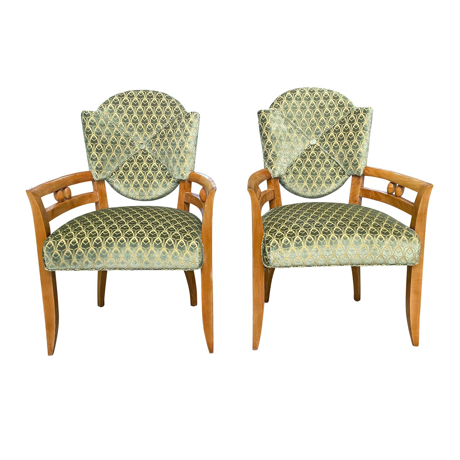 A vintage French Art Deco pair of armchairs made of hand crafted shellac polished Oakwood, designed and produced by André Arbus in good condition. The detailed dining room chairs have a slightly inclined, padded backrest with slim outstretched
