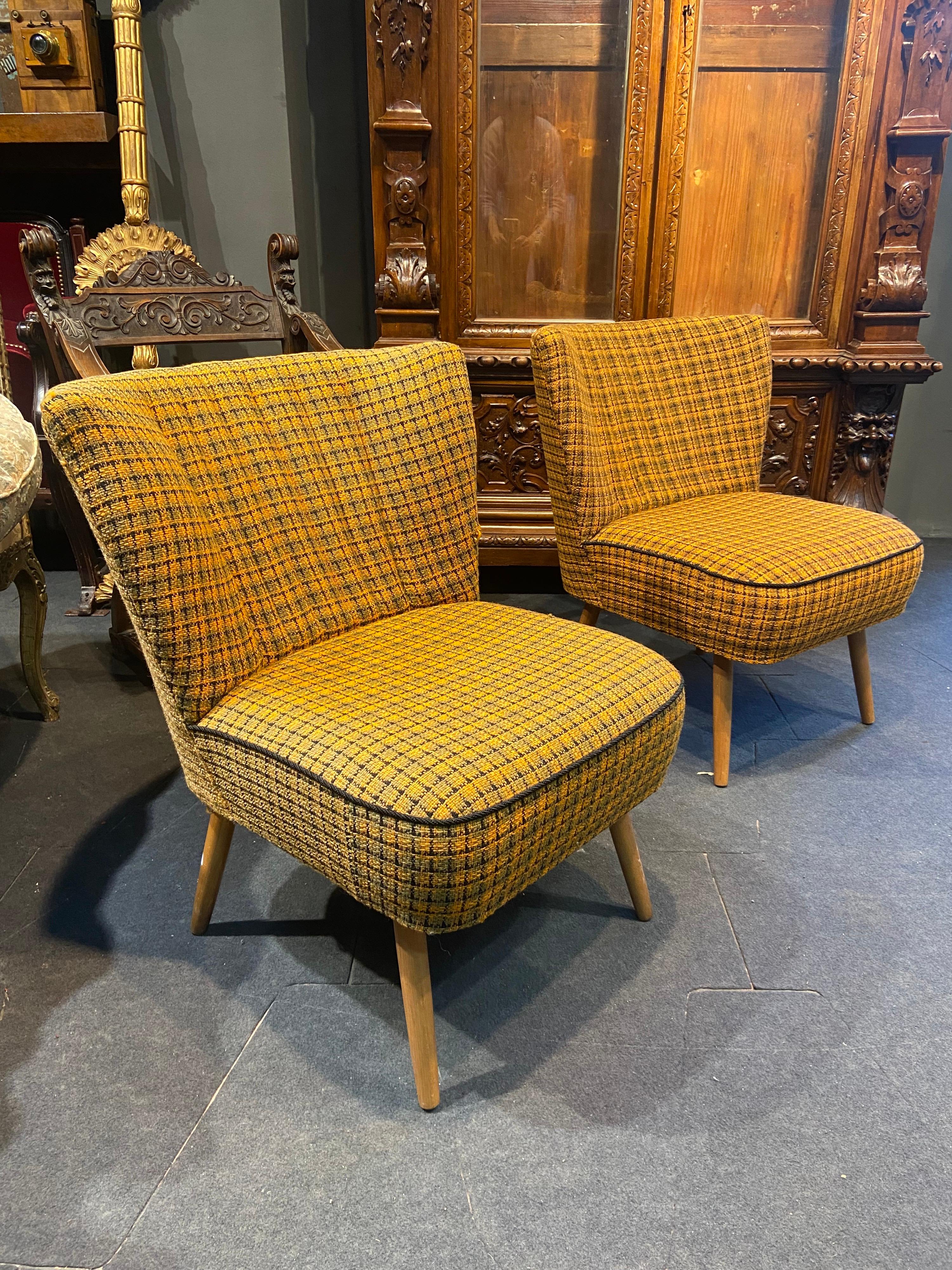 Nice French pair of vintage low chairs in mustard plaid upholstery. Both are raised on small wooden legs and are very comfortable and could be a beautiful accent in any living room.
France, circa 1950.