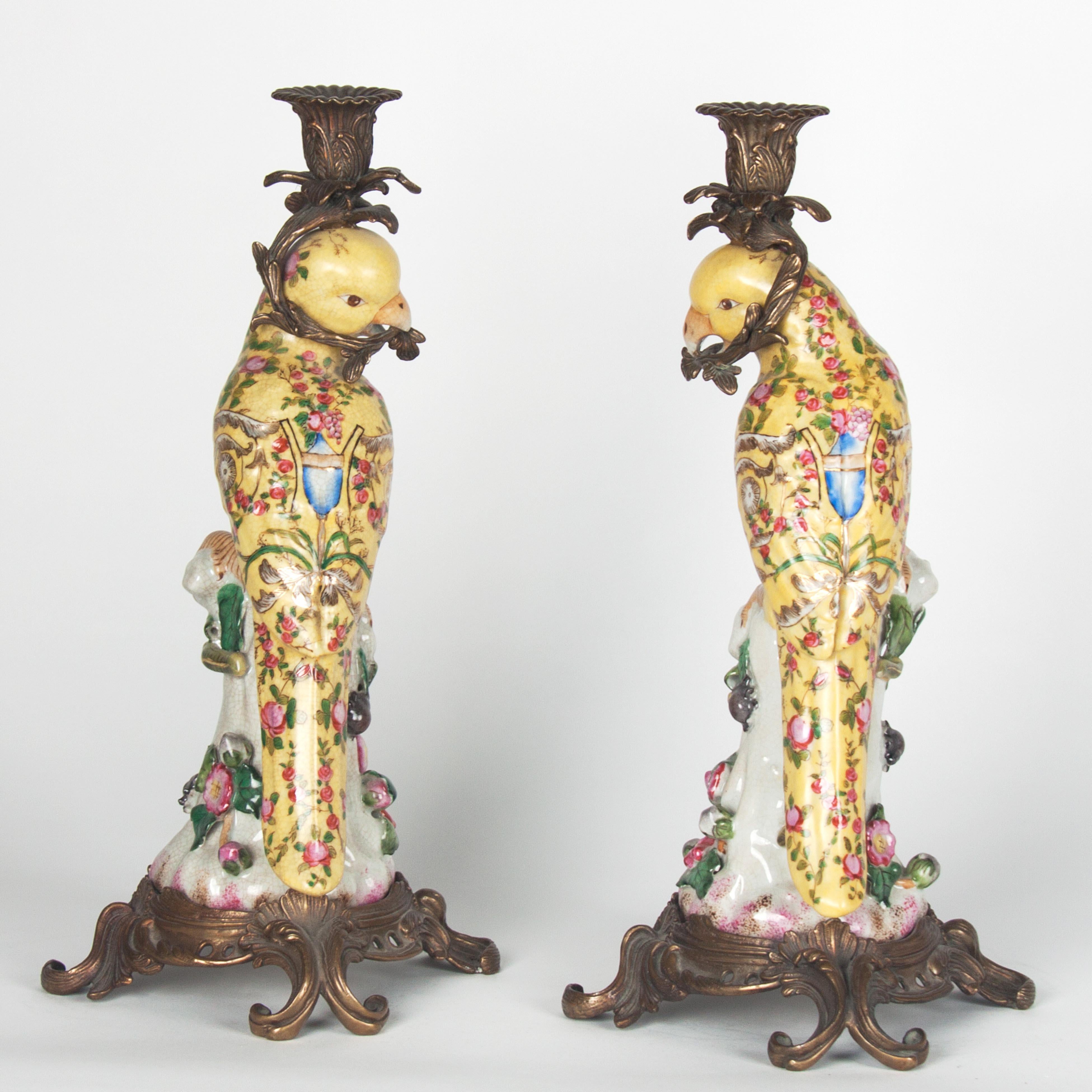 A pair of gilt bronze mounted porcelain parrot candlesticks, probably 20th c.

 