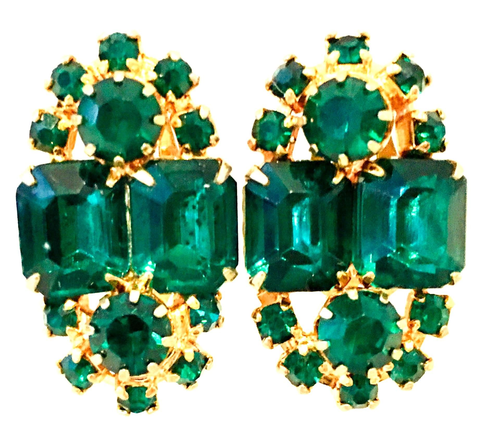 20th Century Pair Of Gold & Austrian Crystal Earrings. These gold plate fancy prong set clip style earrings feature brilliant cut and faceted emerald green Austrian crystal stones.