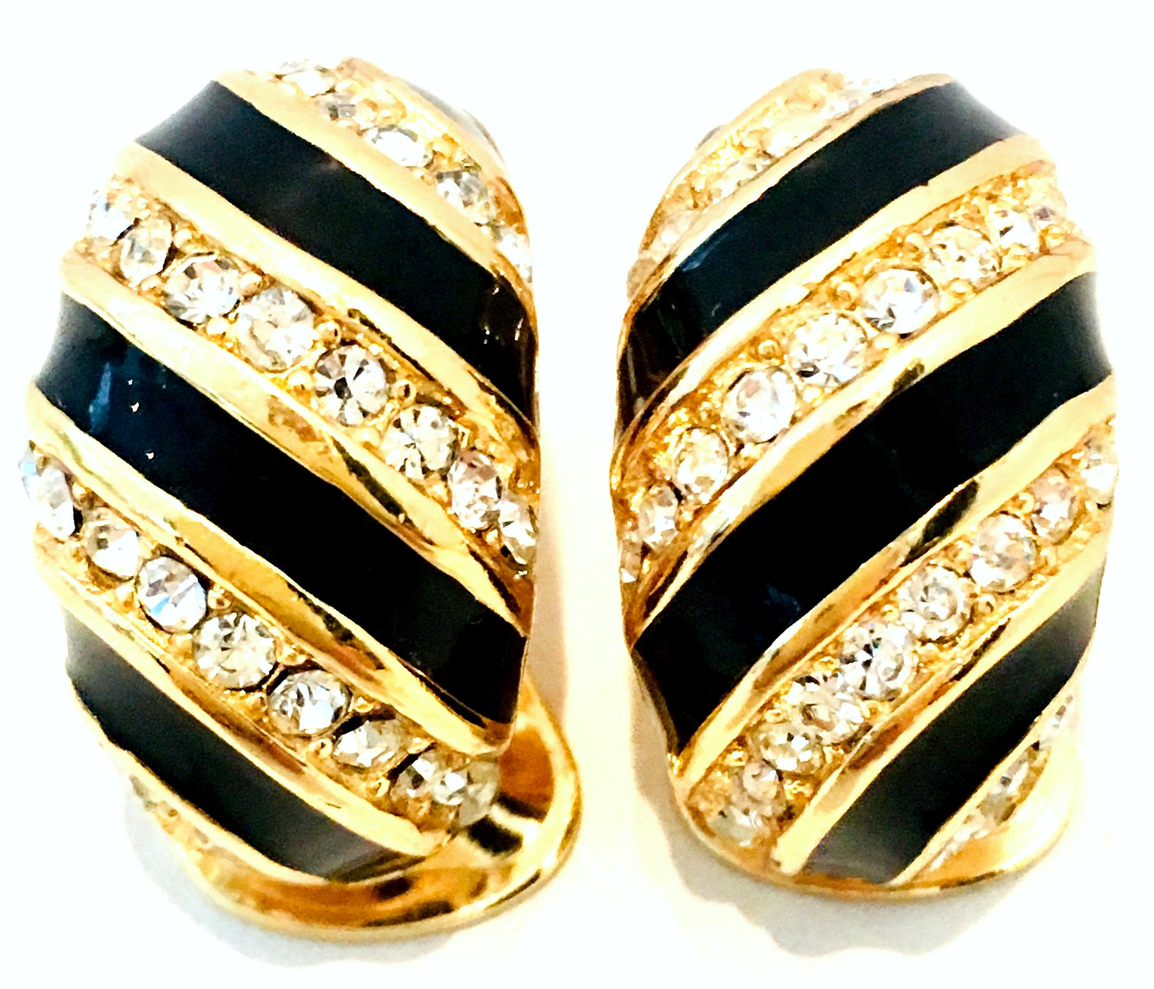20th Century Pair Of Gold, Enamel & Austrian Crystal Earrings By, Christian Dior. These classic and timeless clip style crescent shaped earrings feature gold plate with black enamel and pave set brilliant and colorless Austrian crystals. Signed on