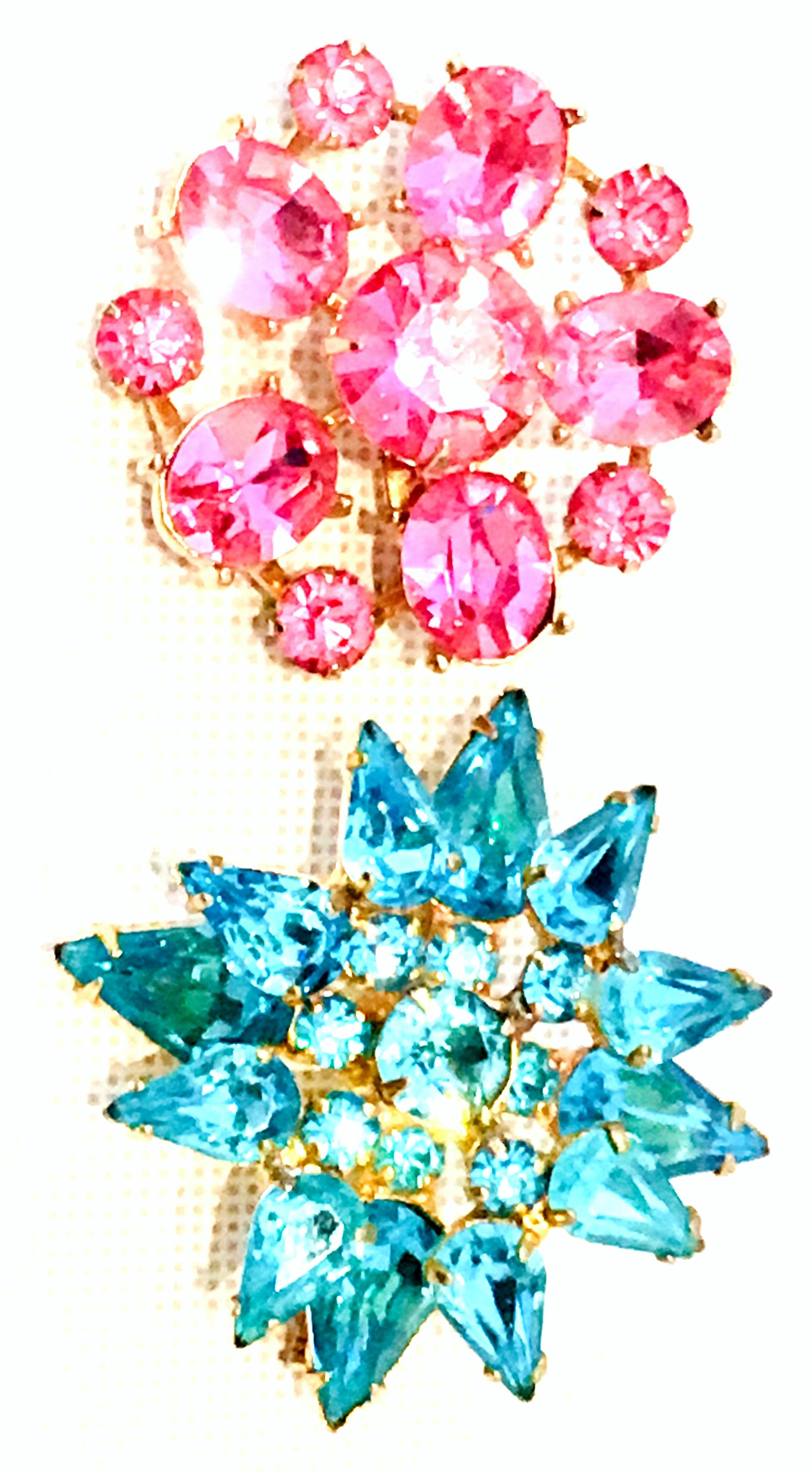 20th Century Pair Of Gold Plate & Austrian Sapphire Crystal Brooches By, Coro
The gold plate pink sapphire dimensional abstract floral brooch features brilliant cut and faceted fancy prong set stones and is signed Coro on the underside. The gold