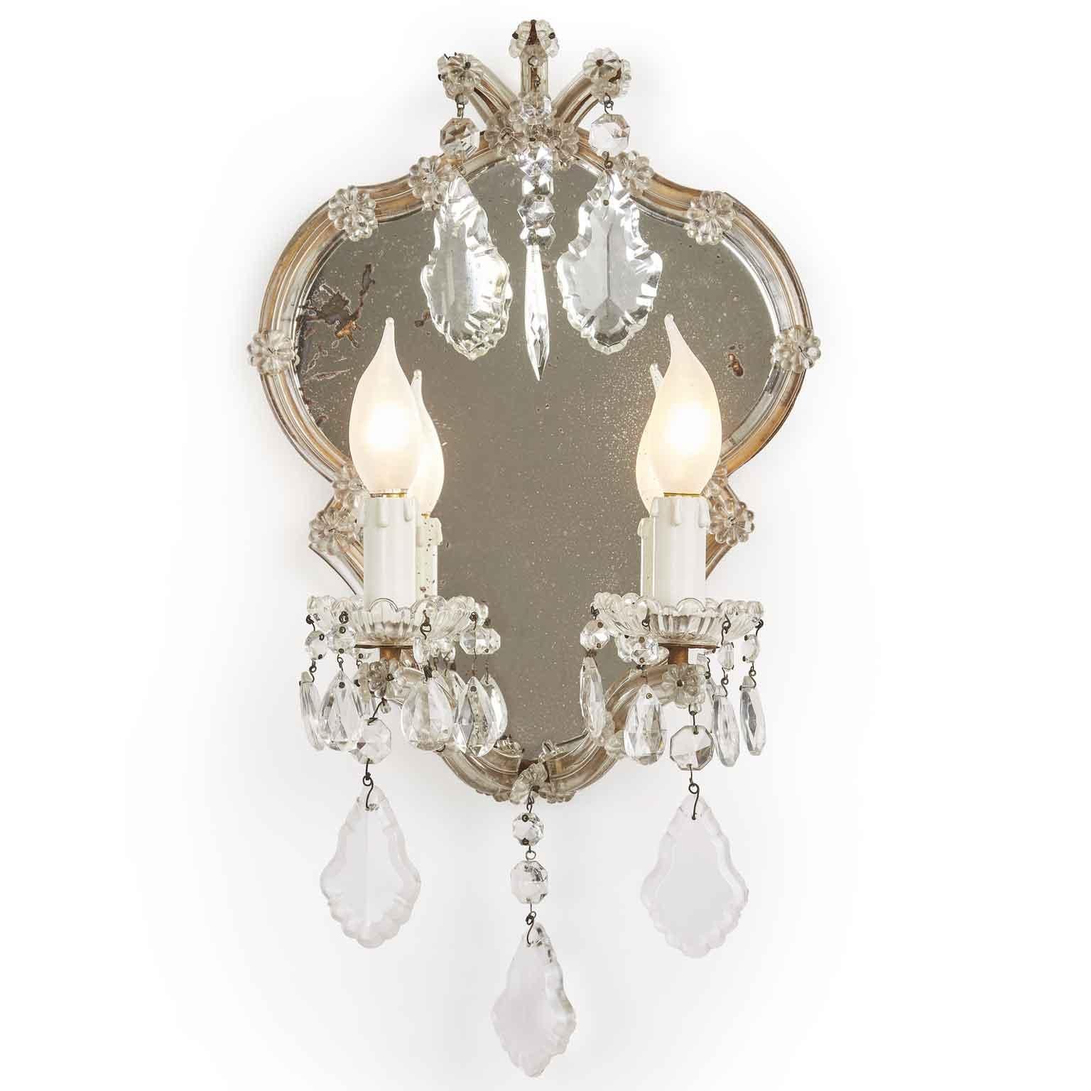 Pair of Hollywood Regency style crystal wall lights, Maria Therese two-light sconces with shaped mercury mirror of Italian origin coming from a private house of Milan.

Two curved arms, fully arranged with cut glass fan shaped pendants, chains and