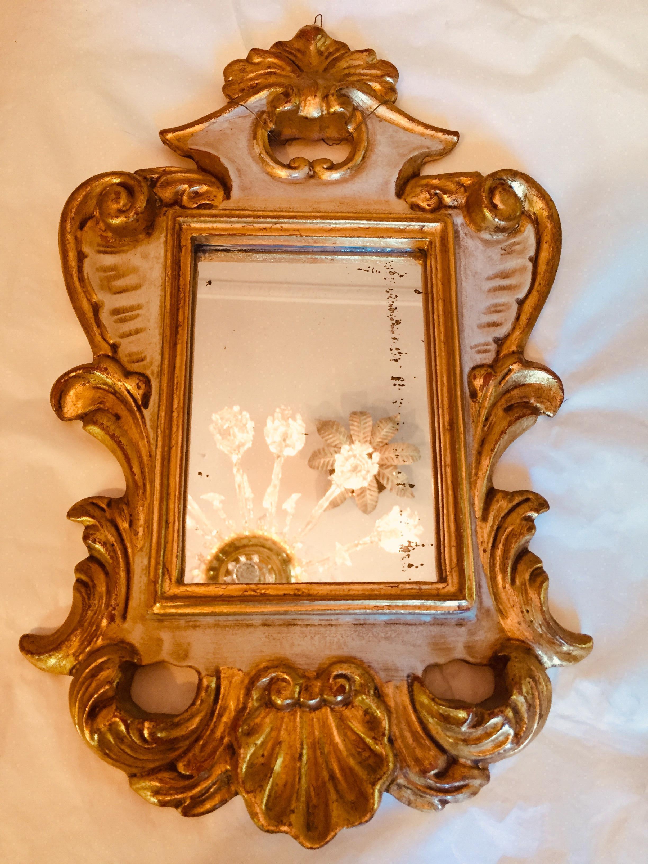 A lovely pair of 20th century Italian mirrors, a small pair of Venetian ivory painted and partially gilded mirrors decorated with acanthus leaf and scrolling hand-carving, in good condition, dating back to late 20th century.
They are a hand-made