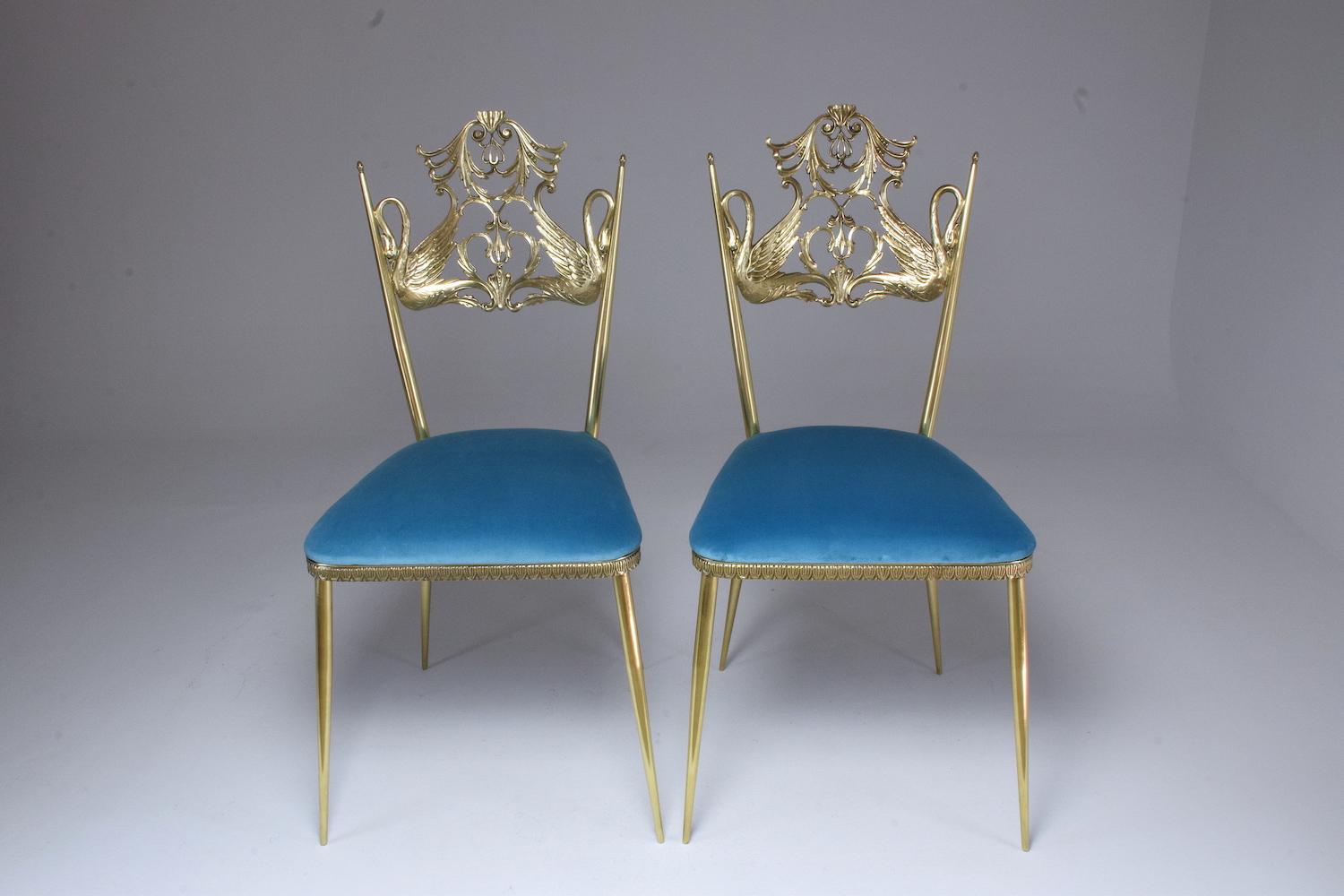 Very beautiful and original mid-century accent or side statement chairs designed in a solid gold brass structure with two swan birds in fully restored condition through careful polishing, new foam padding, and light blue reupholstered velvet