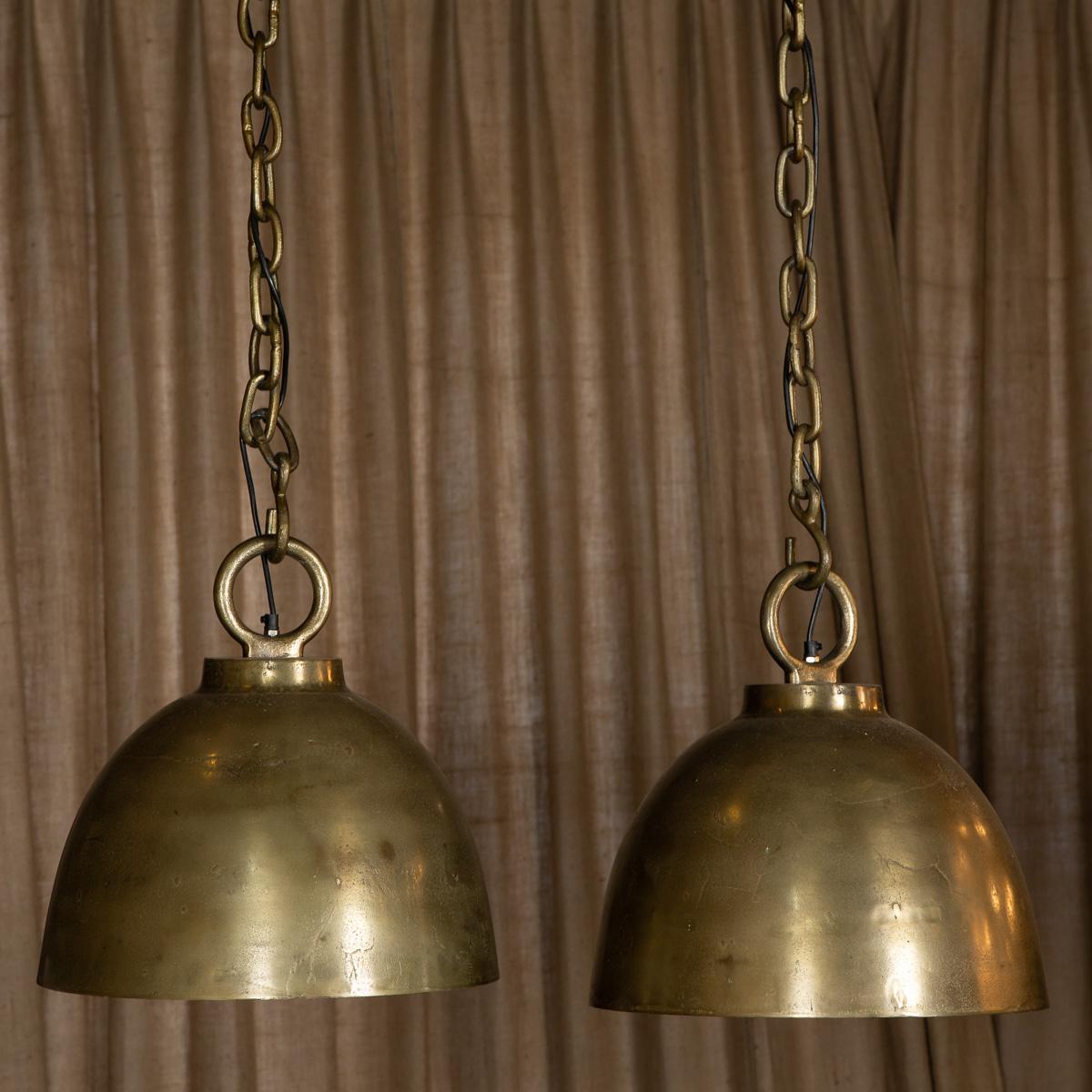 A Pair of large continental brass plated lights in a cloche shape with a heavy brass plated chain 158 cm total length with the light shade.

Condition:
In great condition - wear consistent with age.

Size:
Height: 50 cm
Diameter: 54 cm.