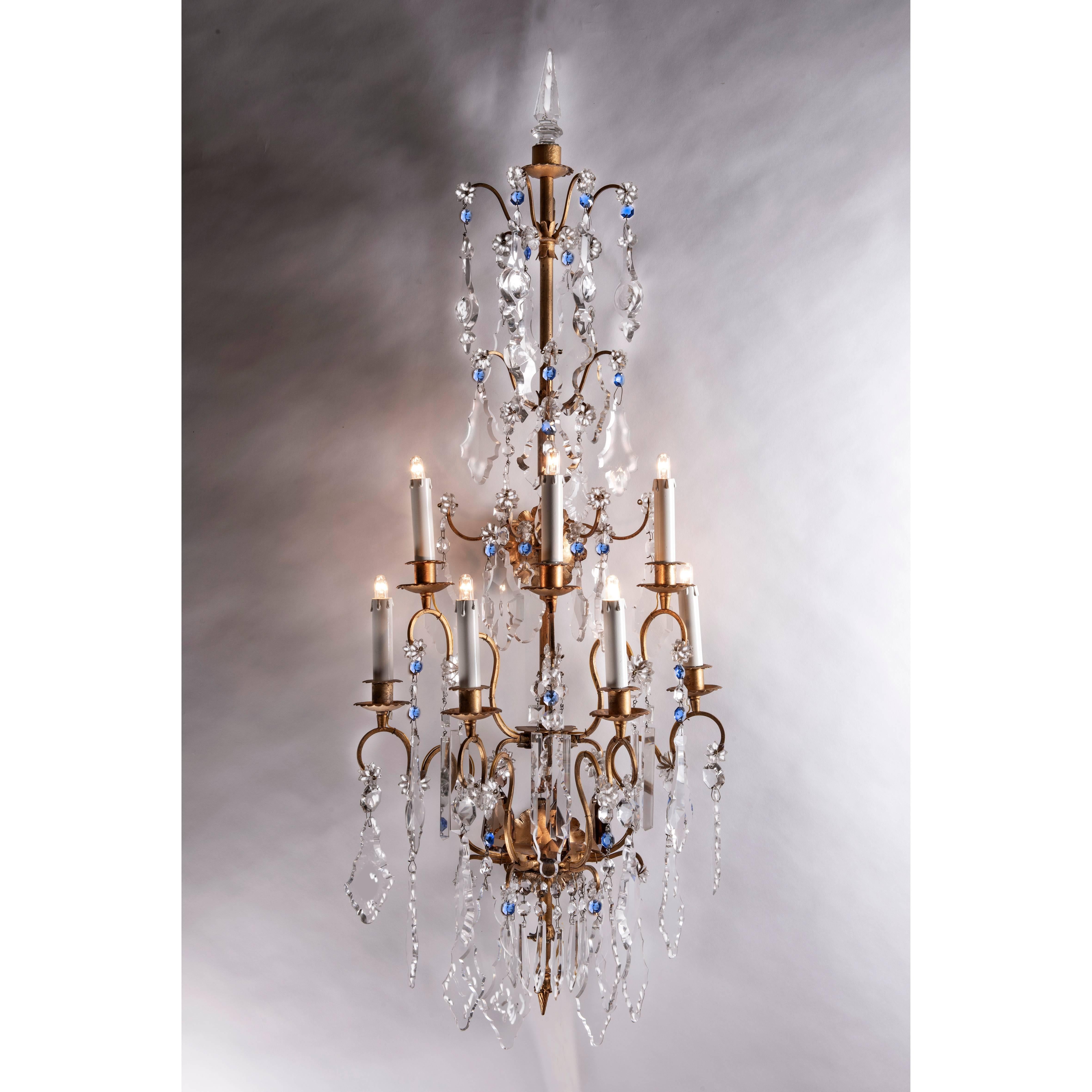 A large pair of Italian sconces, two important crystal and gilt iron seven-light wall brackets, made in Italy circa 1940s but surely inspired by the French Maison Baguès of Paris.
The gilt iron pyramidal structure is fully arranged with fan shaped