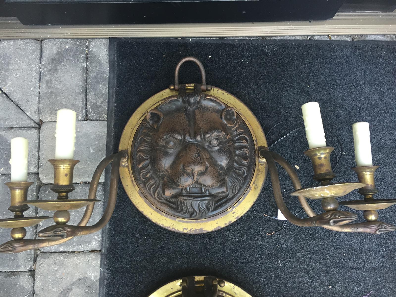 20th century pair of large-scale Regency style iron and brass sconces with lion and snakes.