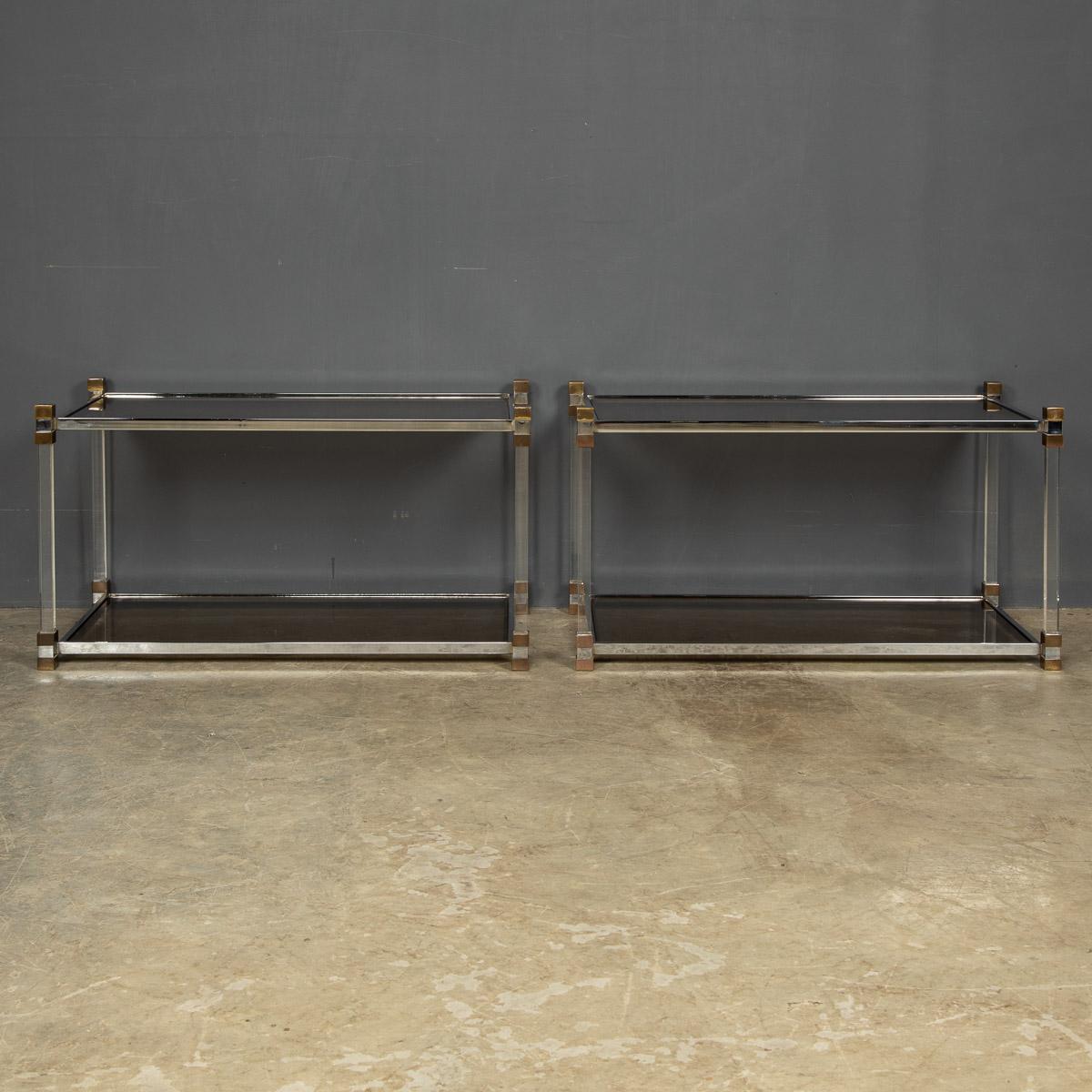 A pair of 20th Century French side tables with lucite and brass frames with two smoked glass shelves, circa 1970's.

CONDITION
In Good Condition - wear consistent with age, (please refer to photographs).

SIZE
Width: 80cm
Height: 44cm
Depth: 42cm