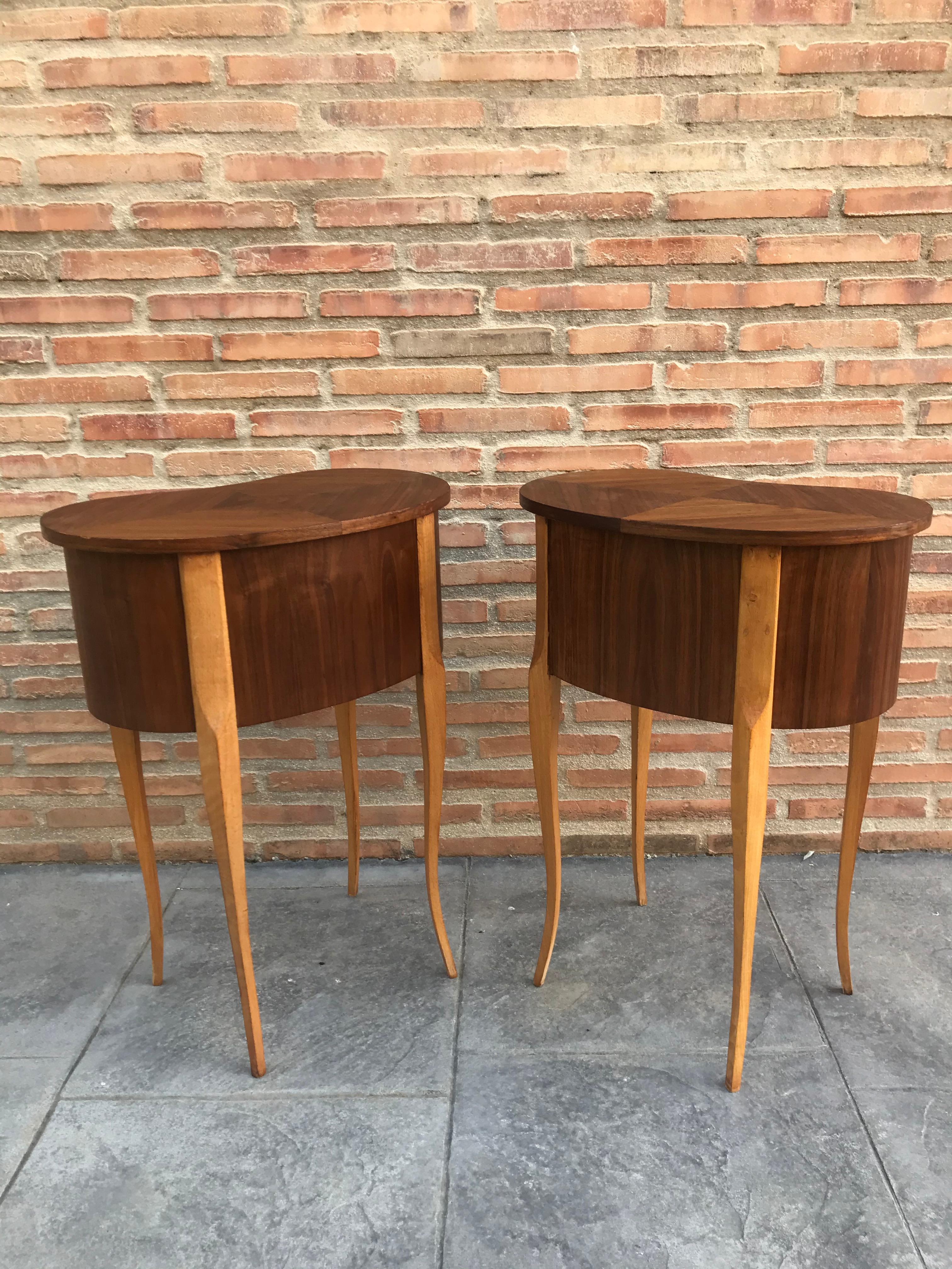 20th century pair of walnut nightstands with kidney shape and two drawers.