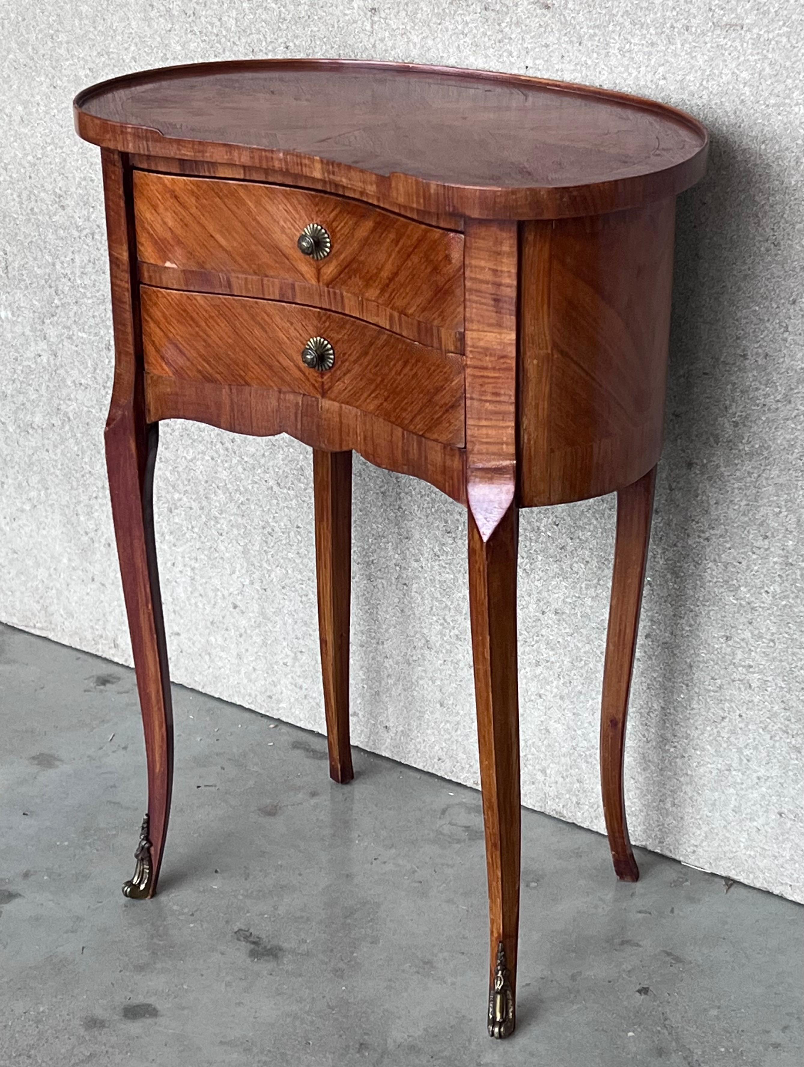 20th century pair of walnut nightstands with kidney shape and two drawers.